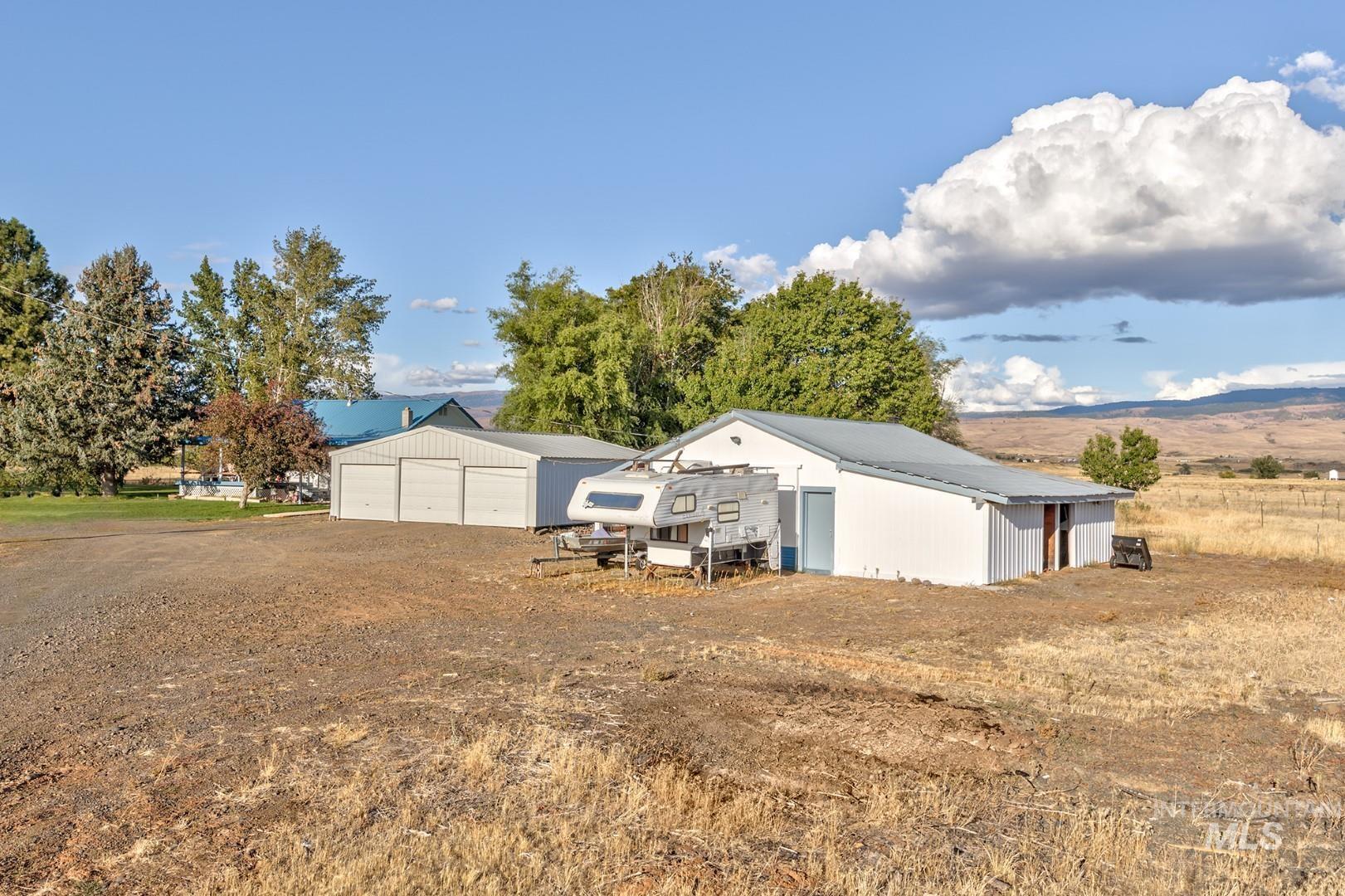 View of yard featuring an outbuilding and a garage