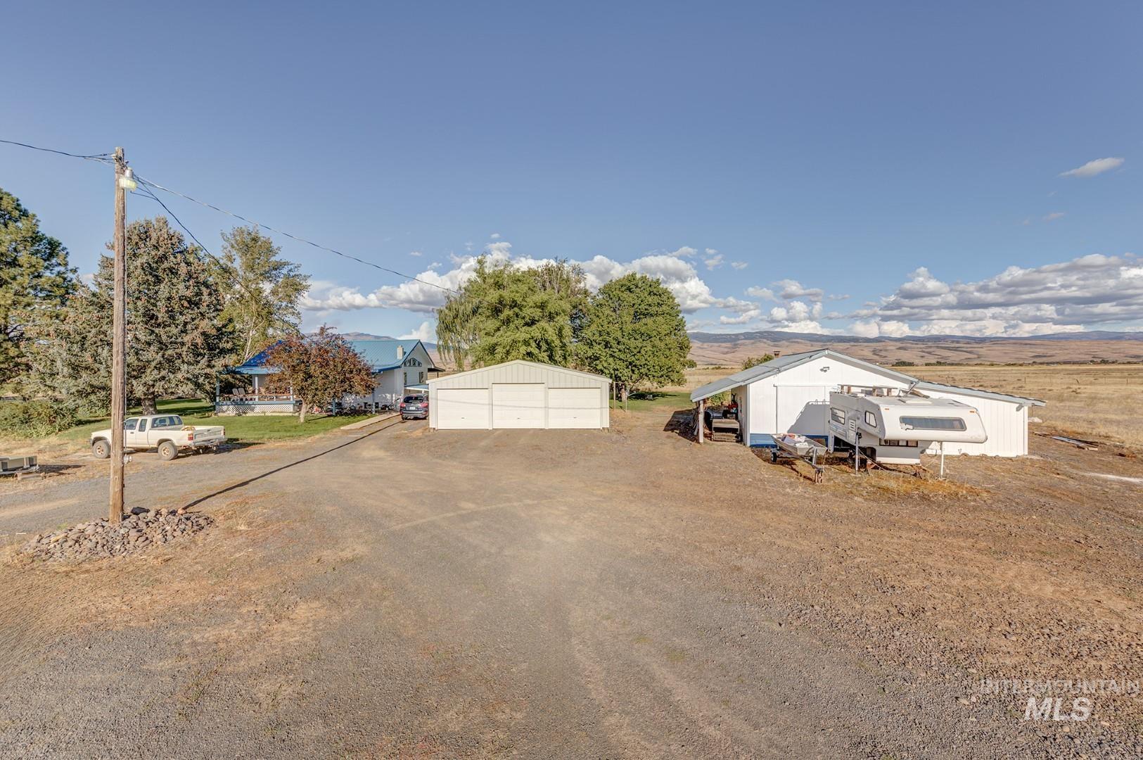 View of front of house with a garage and an outdoor structure
