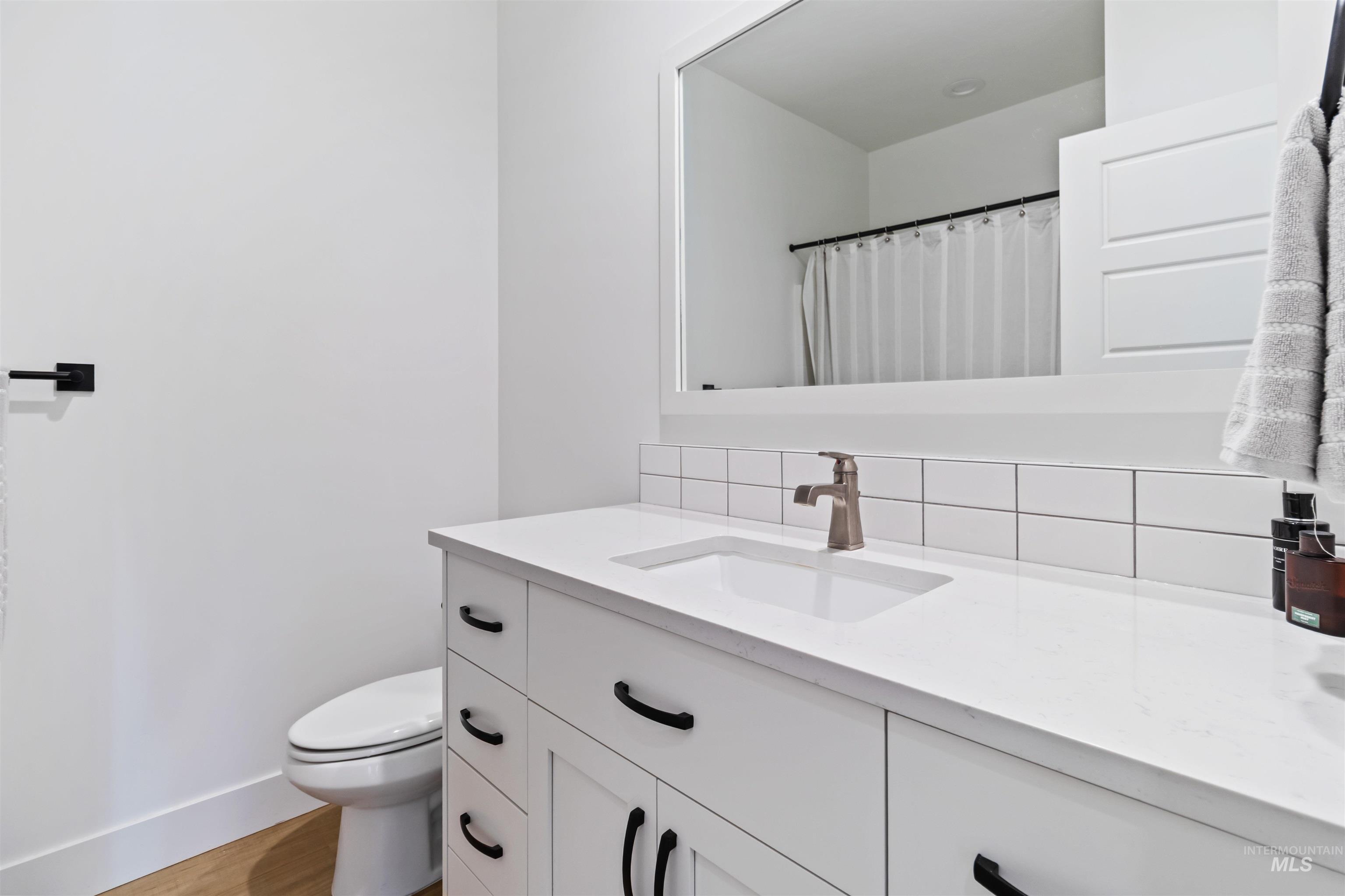 Full bathroom featuring vanity and light wood-style floors