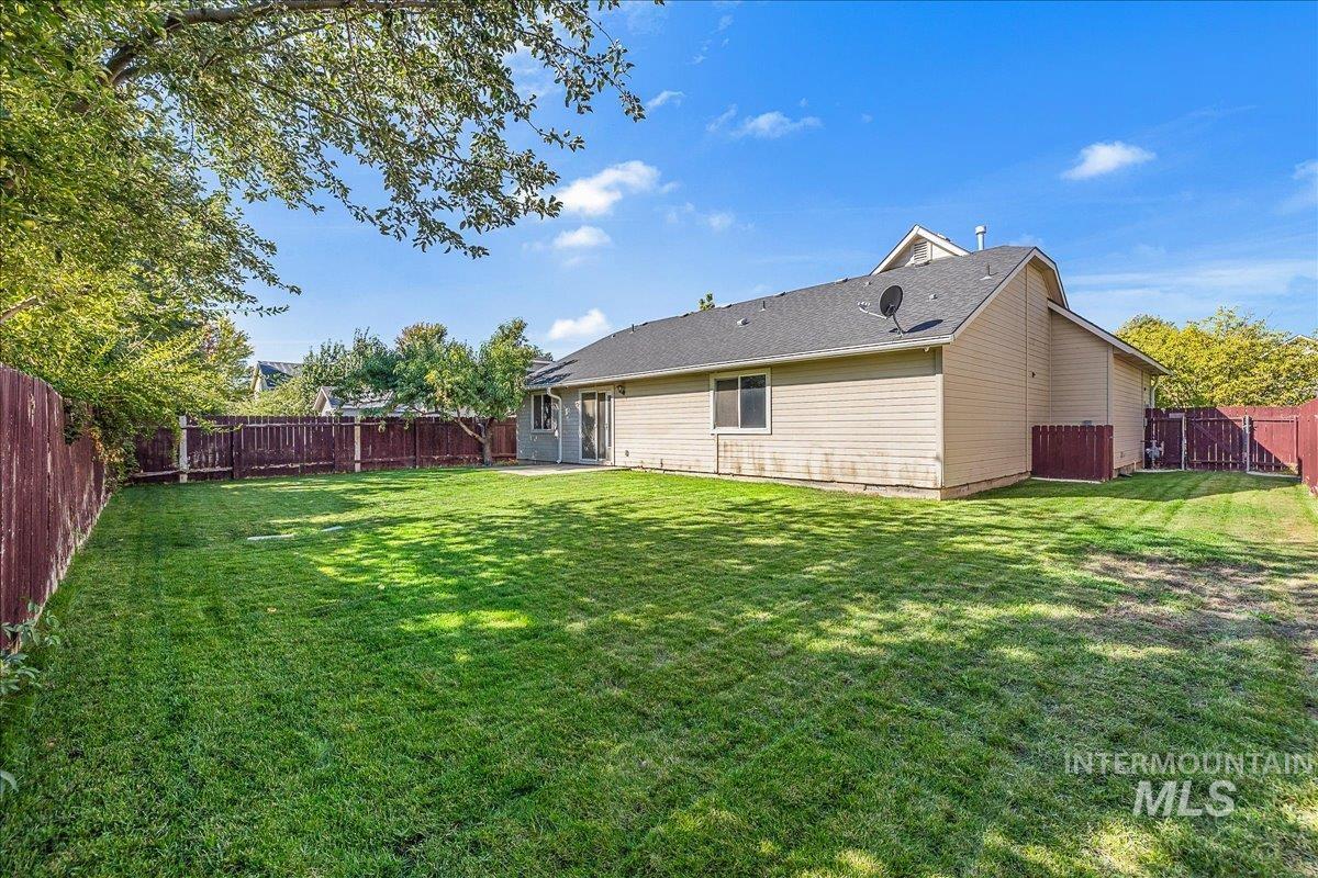 Back of house featuring a fenced backyard and a patio