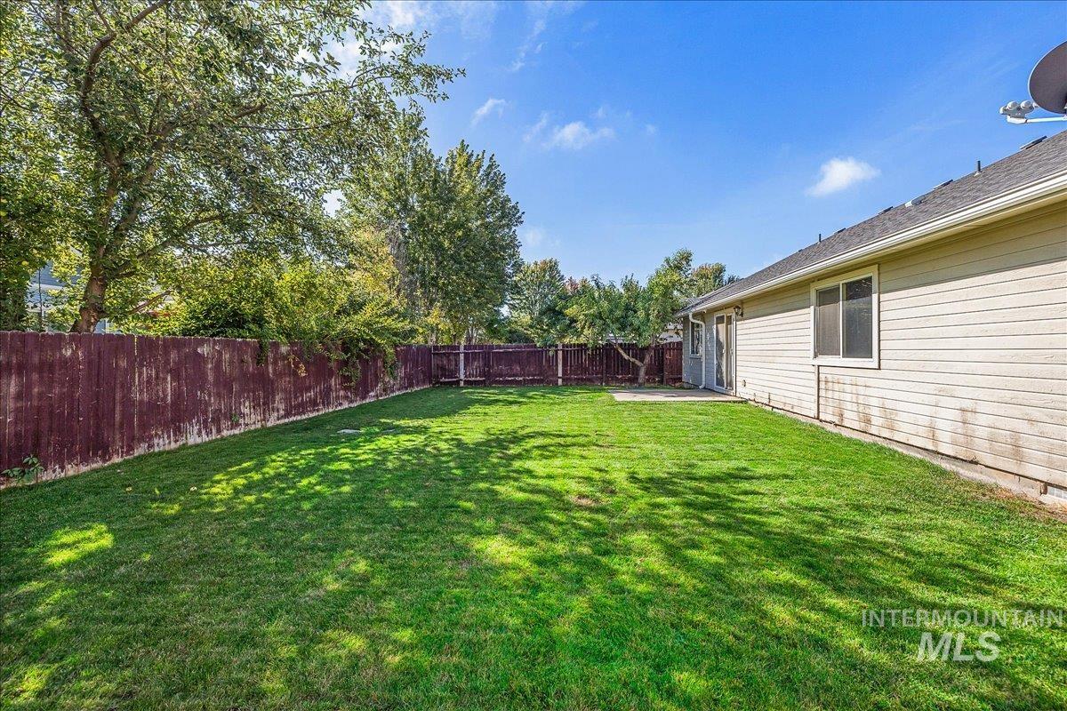 Fenced backyard with a patio area