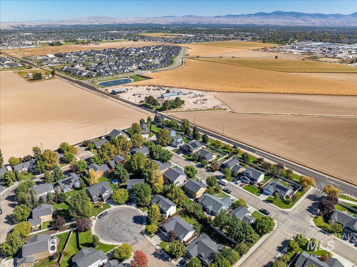 Aerial perspective of suburban area with a mountainous background
