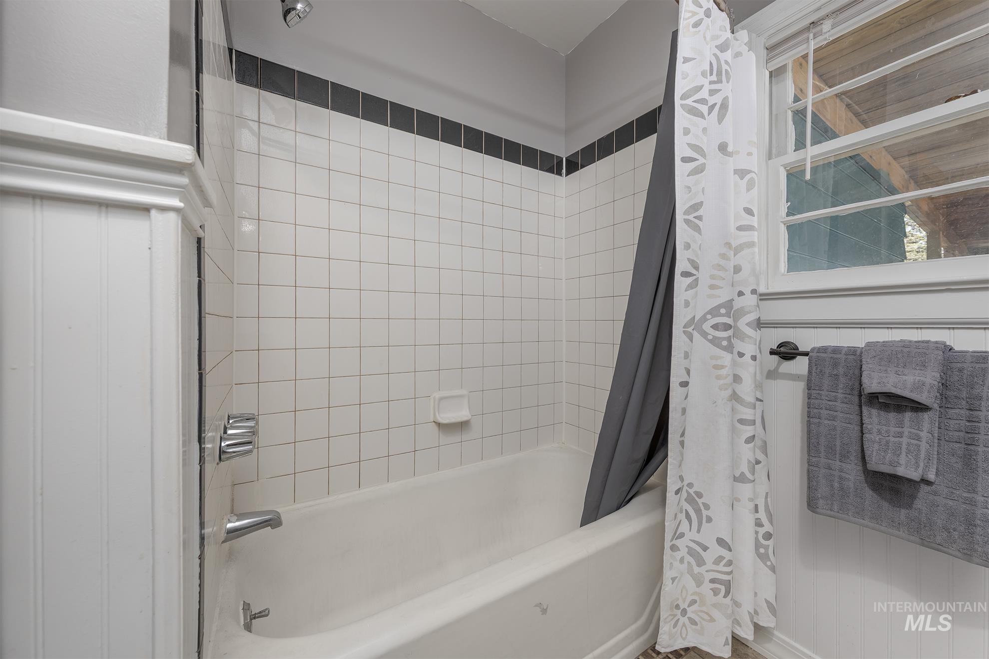 Full bath featuring shower / bathtub combination with curtain