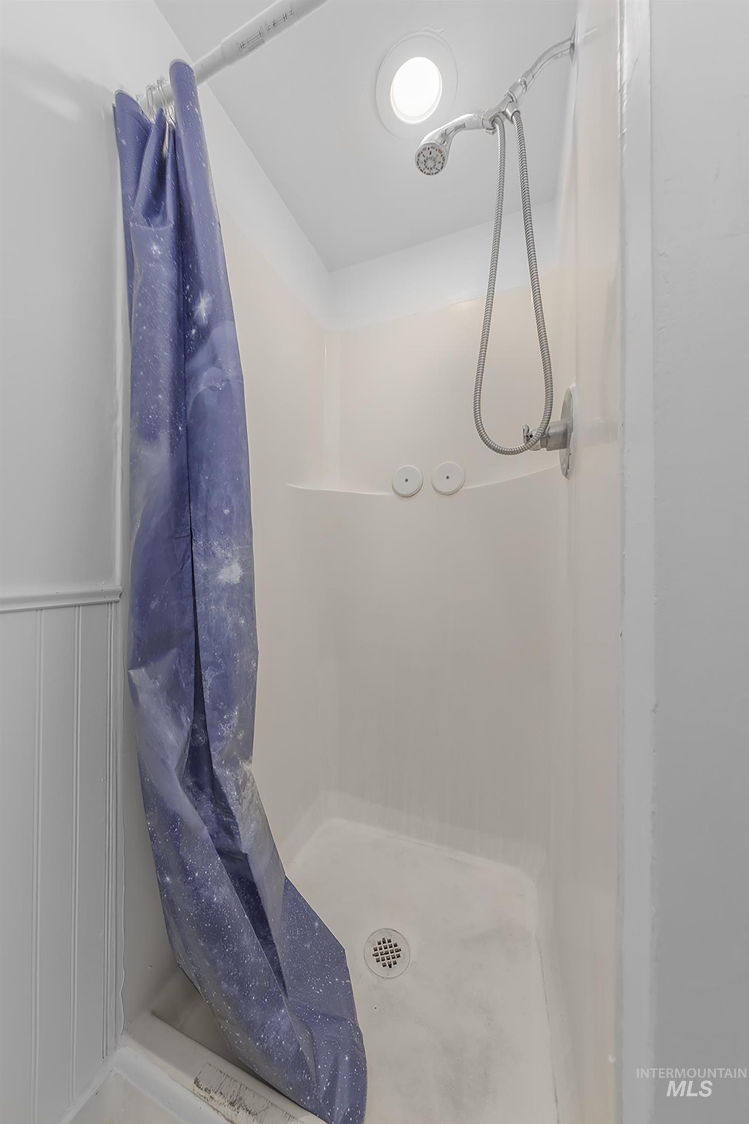 Full bathroom featuring a stall shower