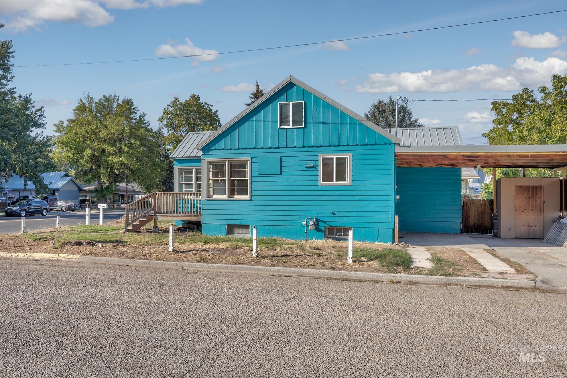 View of side of home featuring a metal roof and an attached carport