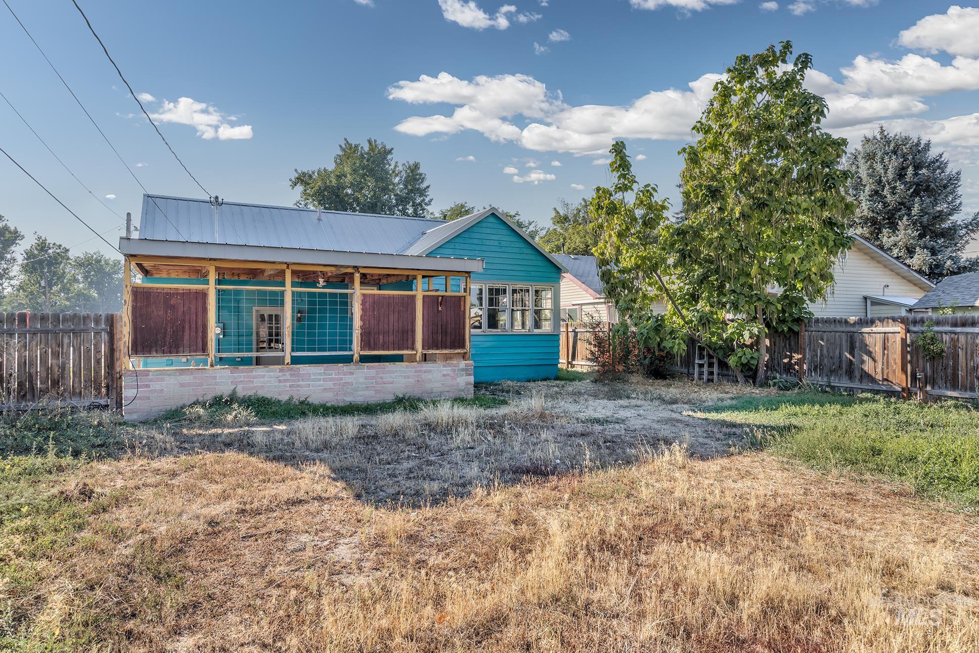 Back of property featuring a metal roof