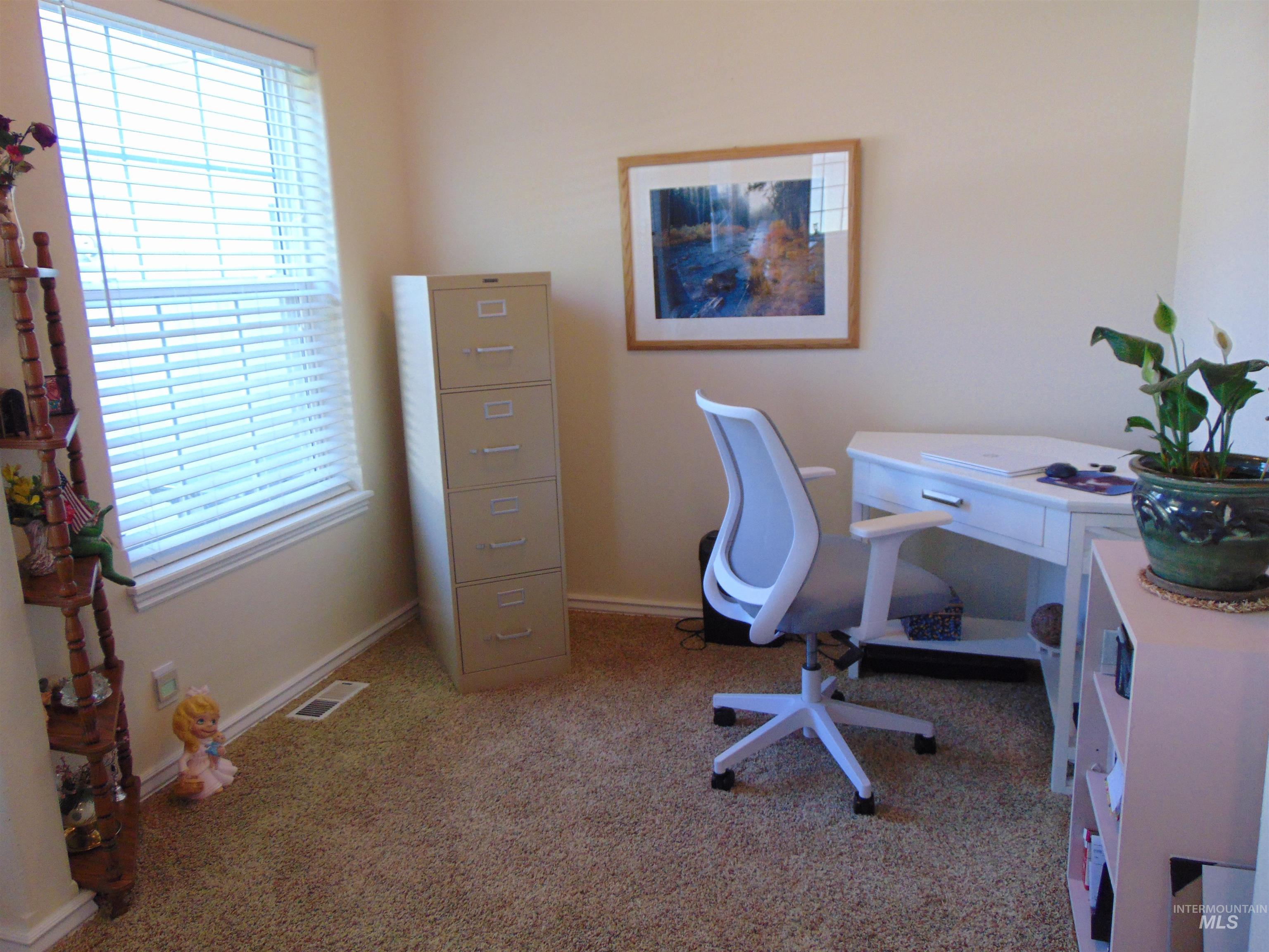Office featuring light carpet and baseboards