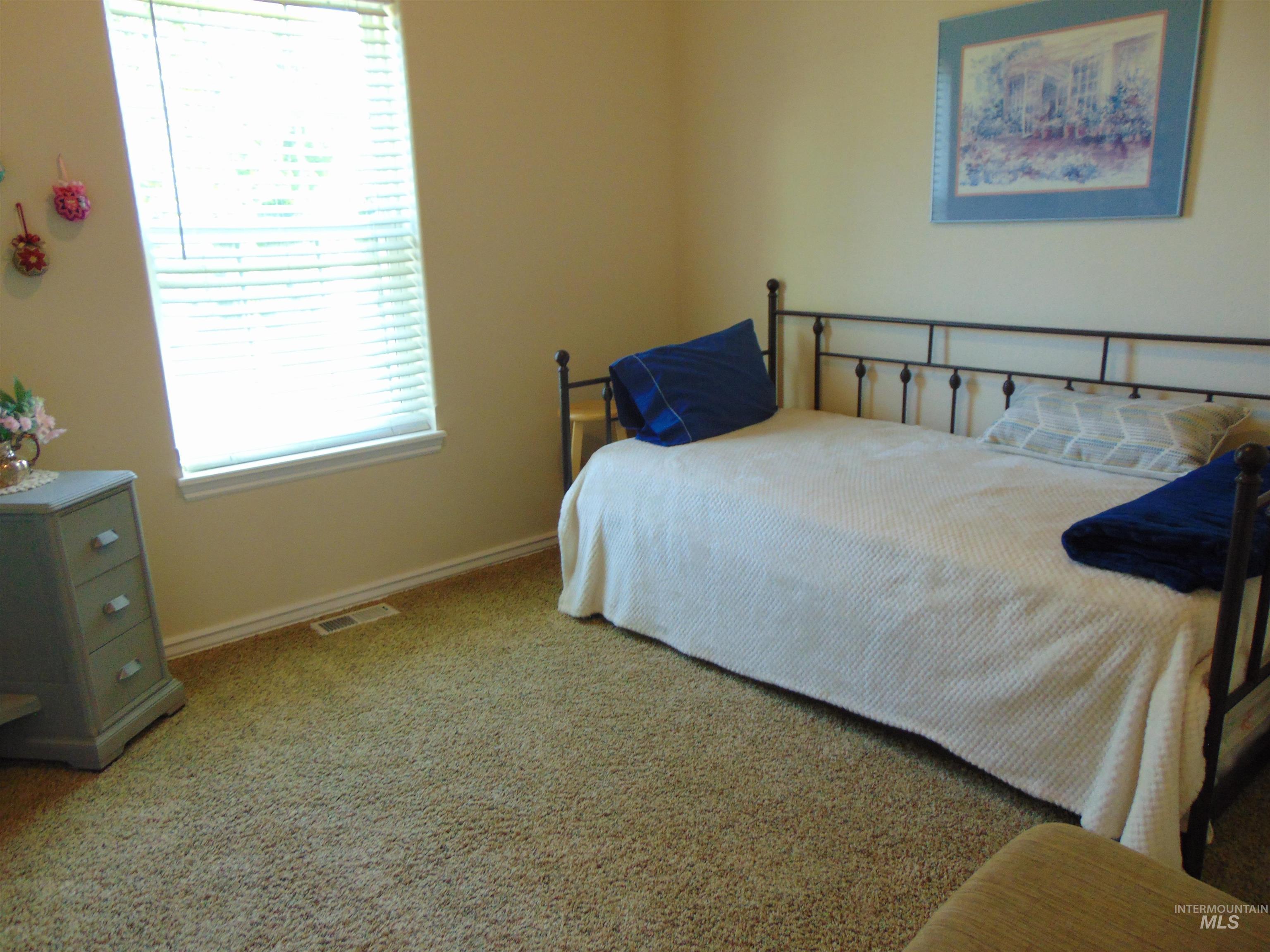Bedroom featuring carpet flooring and baseboards