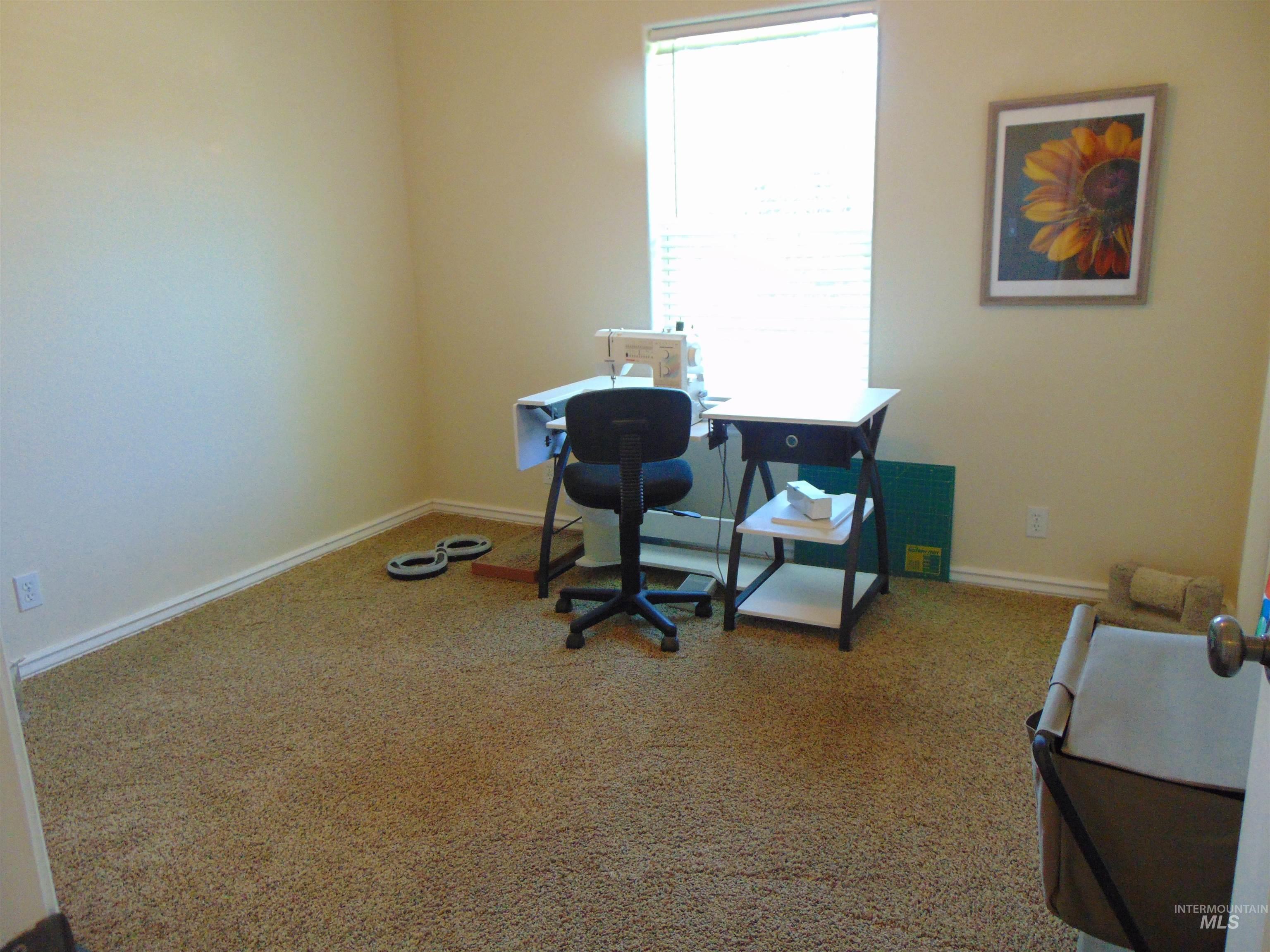 Carpeted home office with baseboards