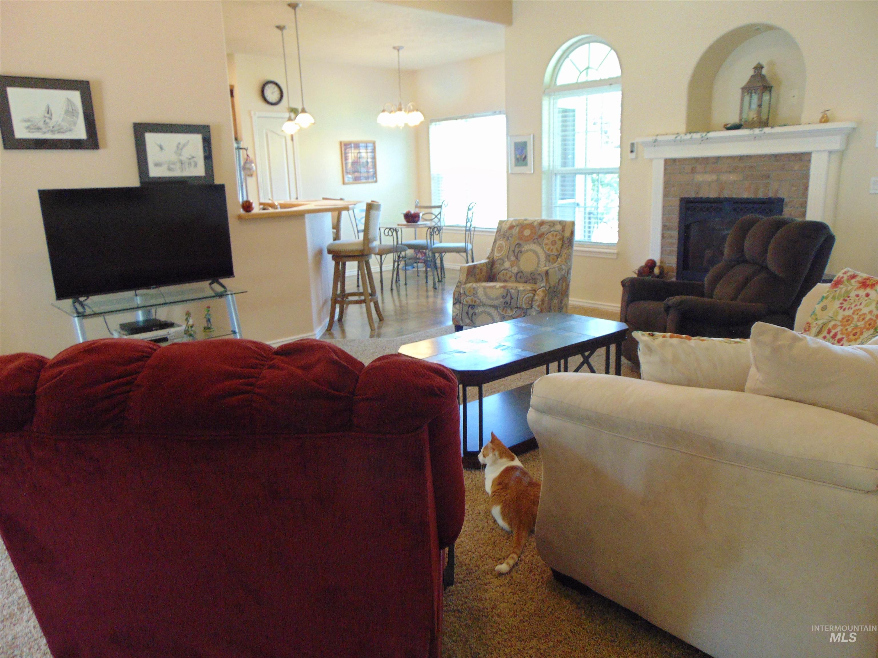 Living room featuring a fireplace and a chandelier