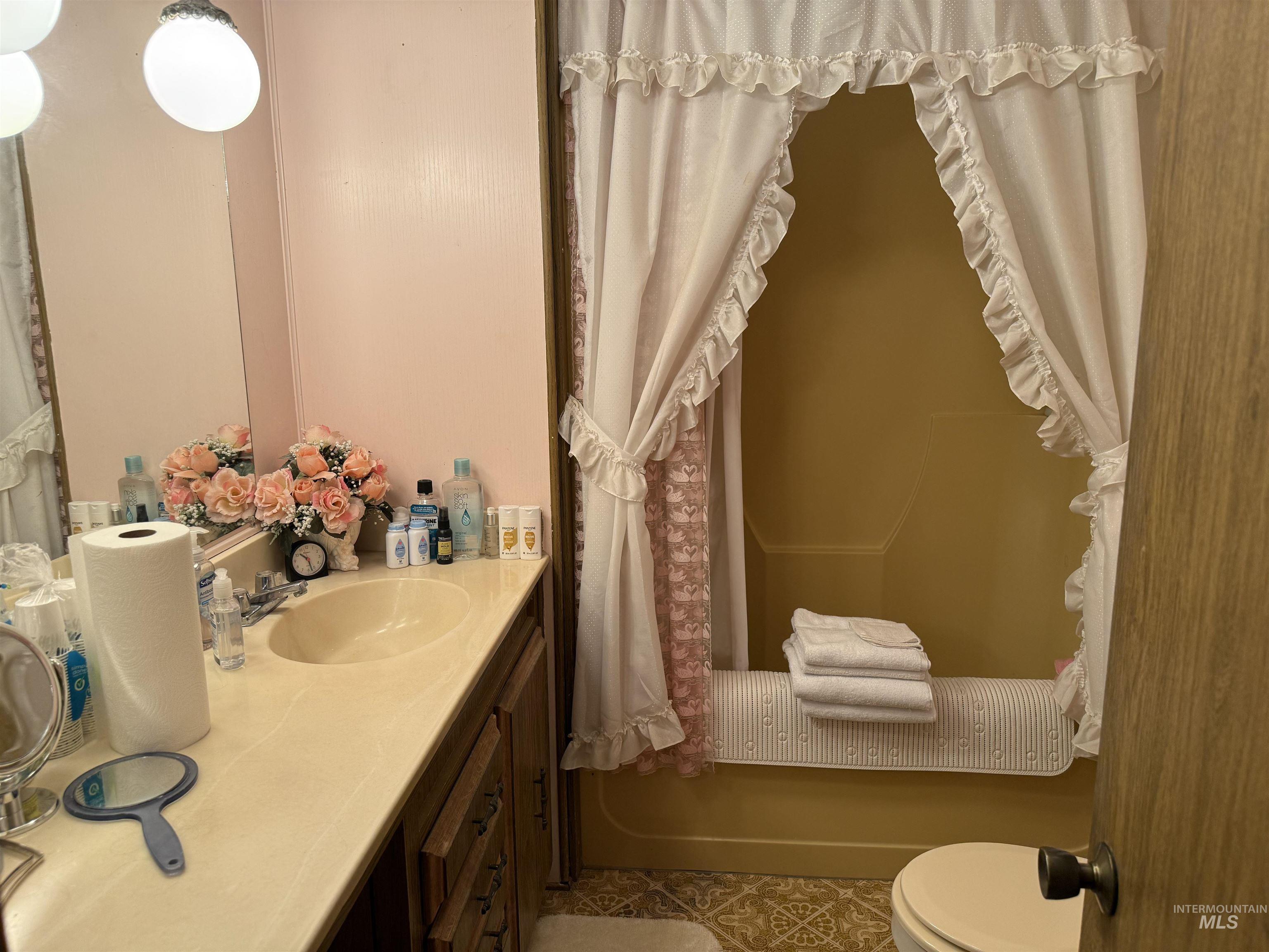 Full bathroom with vanity and dark tile patterned flooring