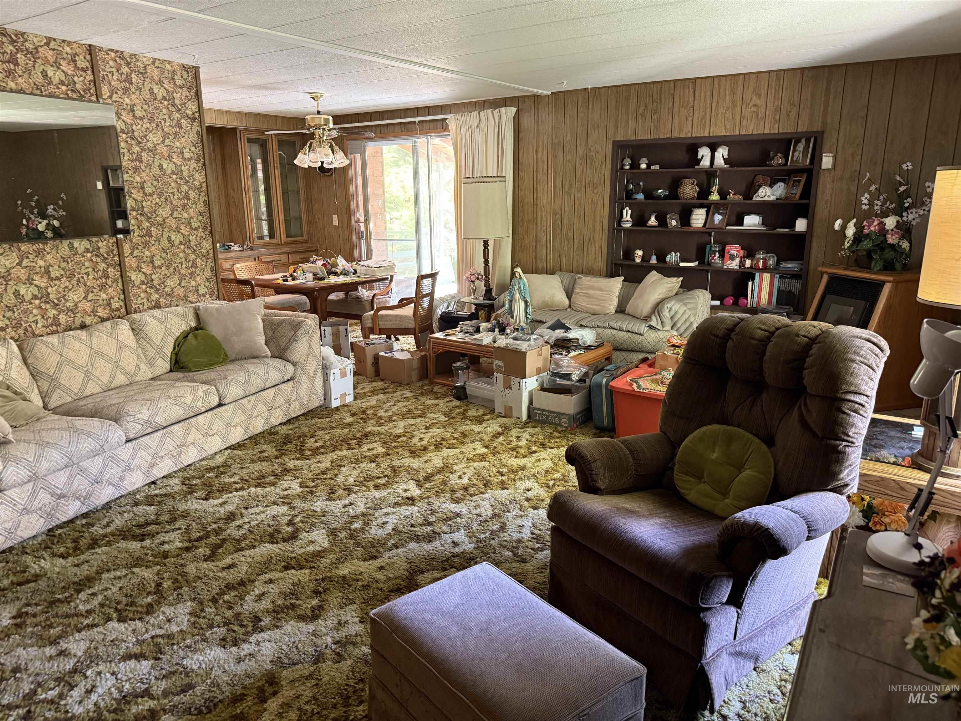 Living area featuring carpet floors and wood walls