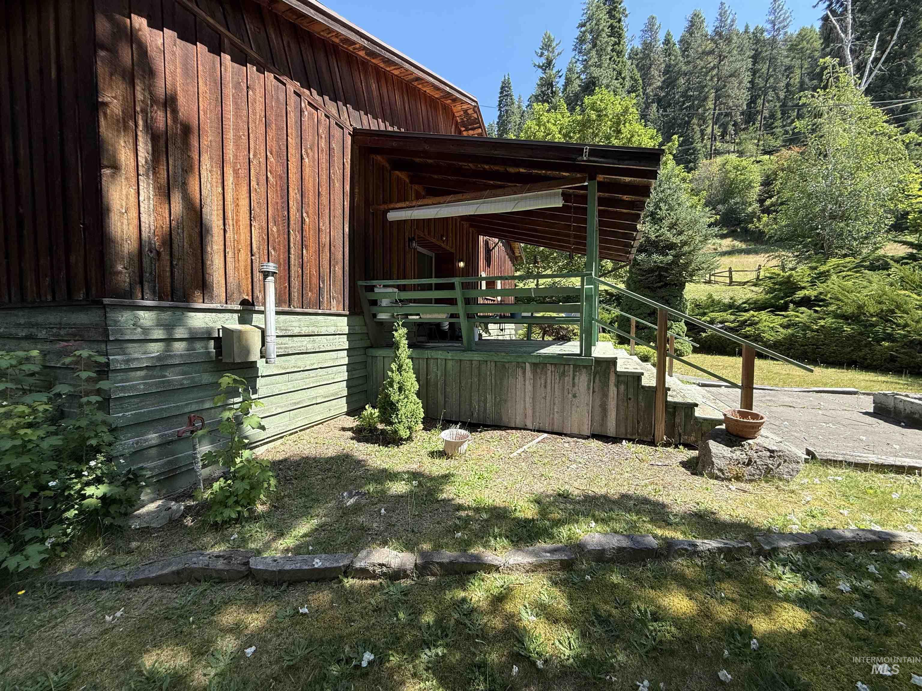 View of yard with stairs and a deck