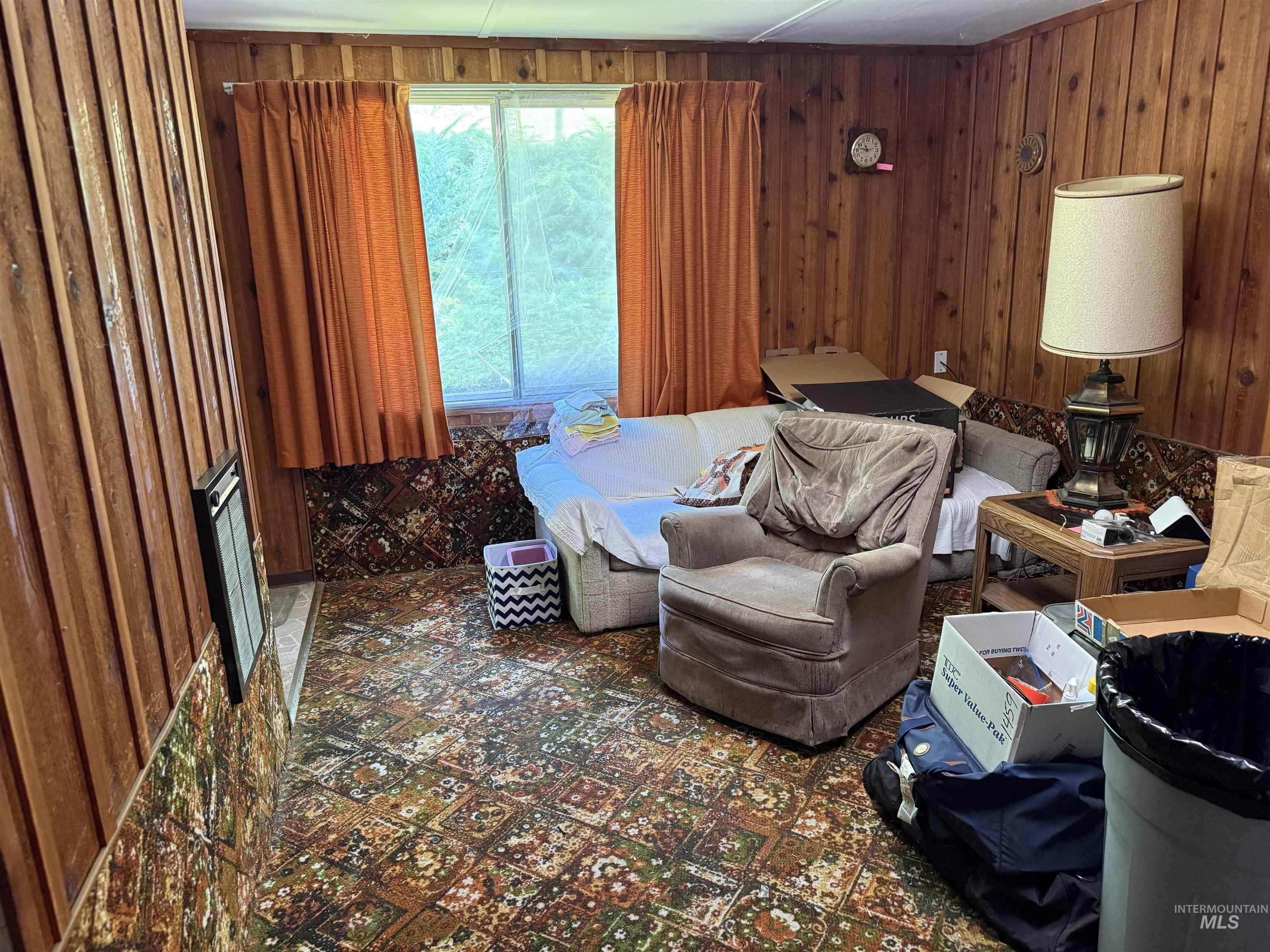 Sitting room featuring wooden walls