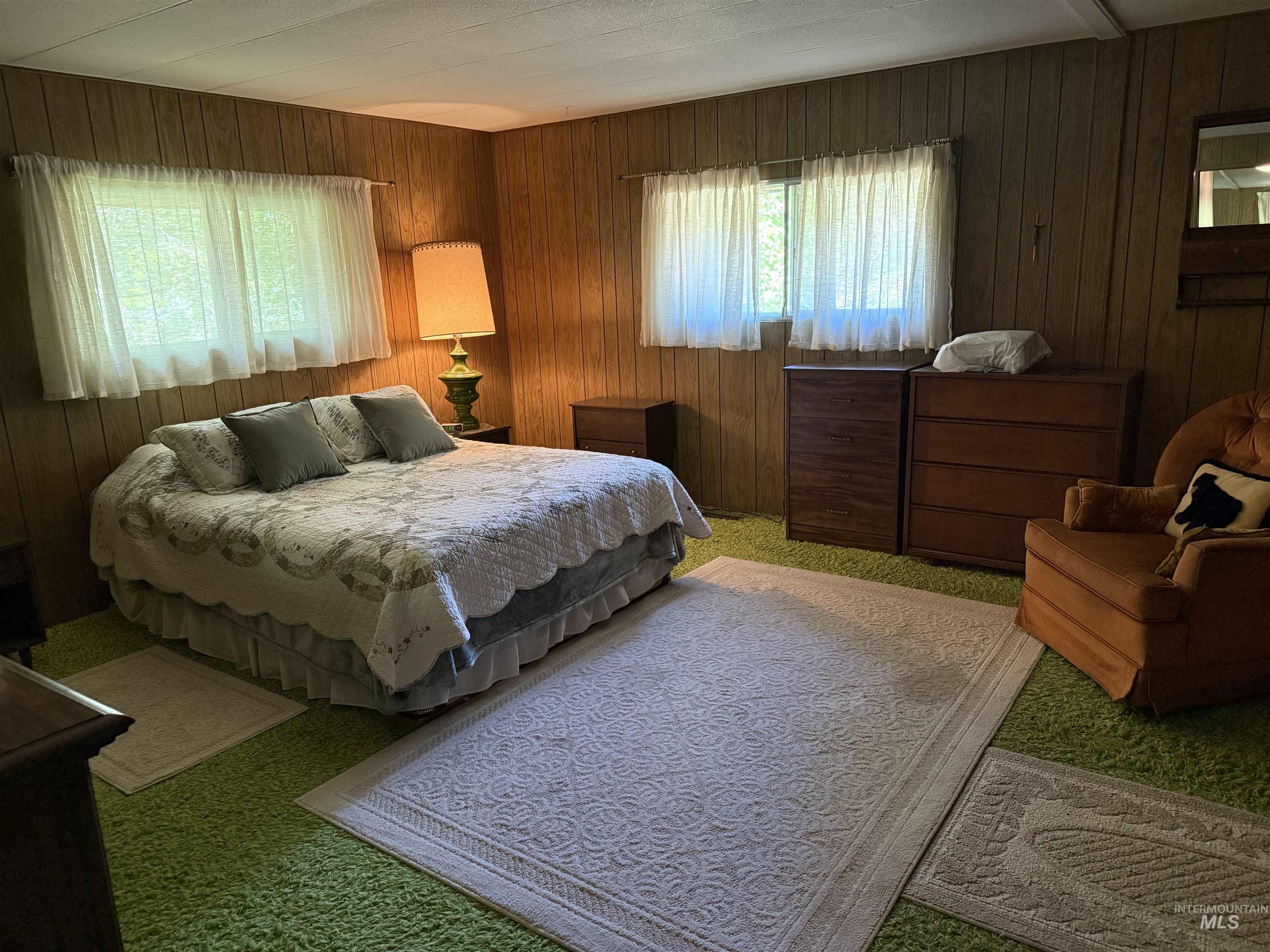 Carpeted bedroom with wooden walls
