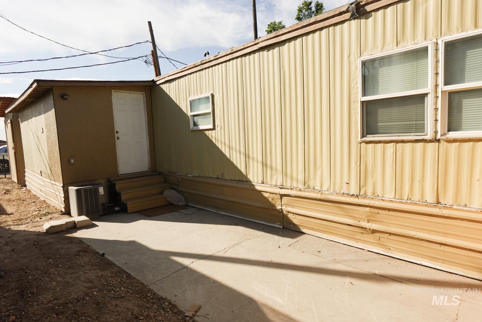 View of side of property featuring entry steps