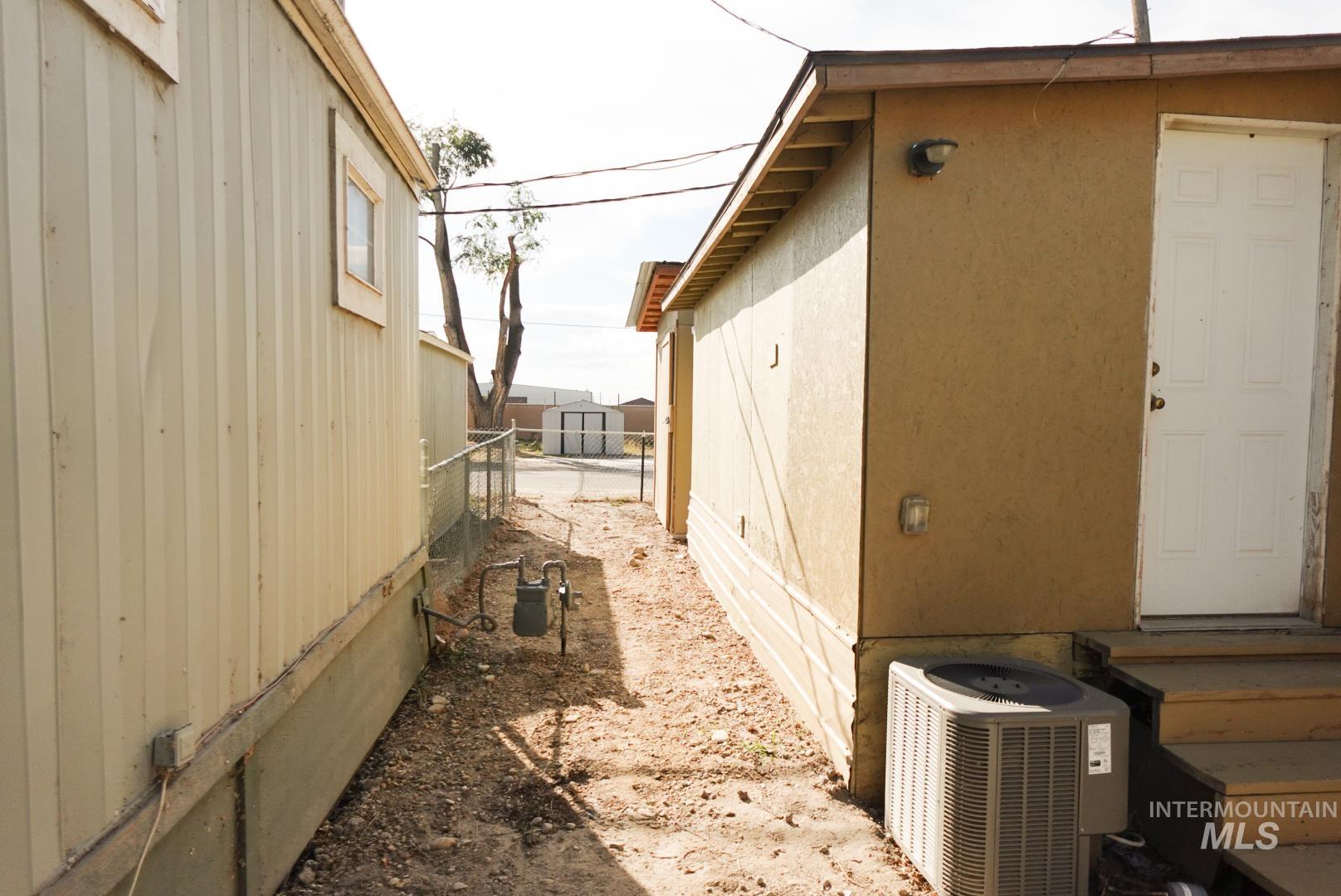 View of home's exterior with a central AC unit and stucco siding
