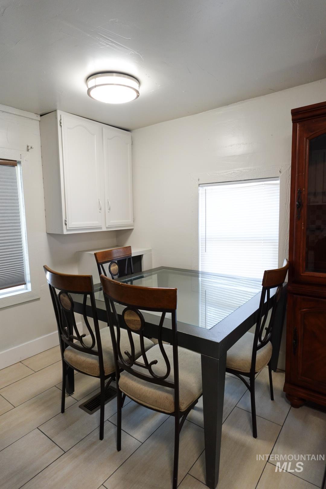 Dining area with light wood-type flooring and baseboards