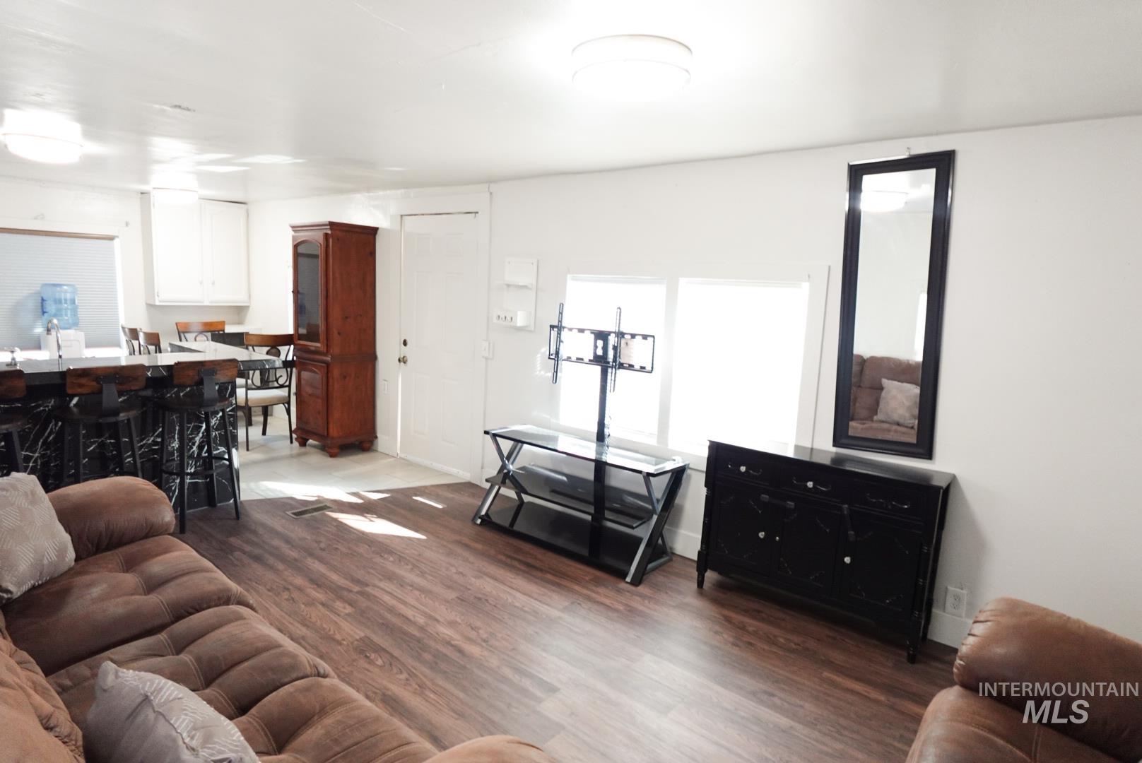 Living area with dark wood-style floors