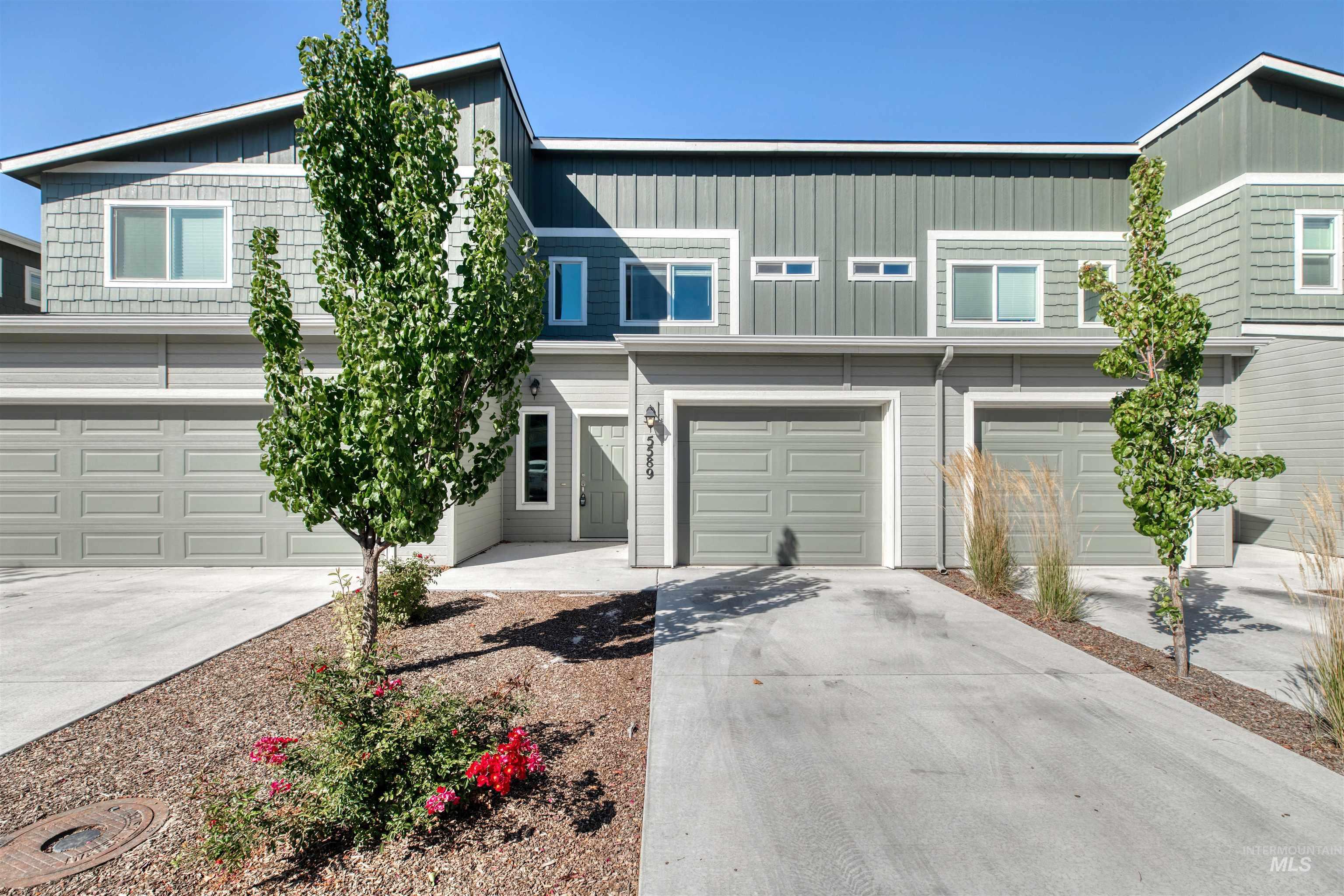 View of front facade with concrete driveway and a garage