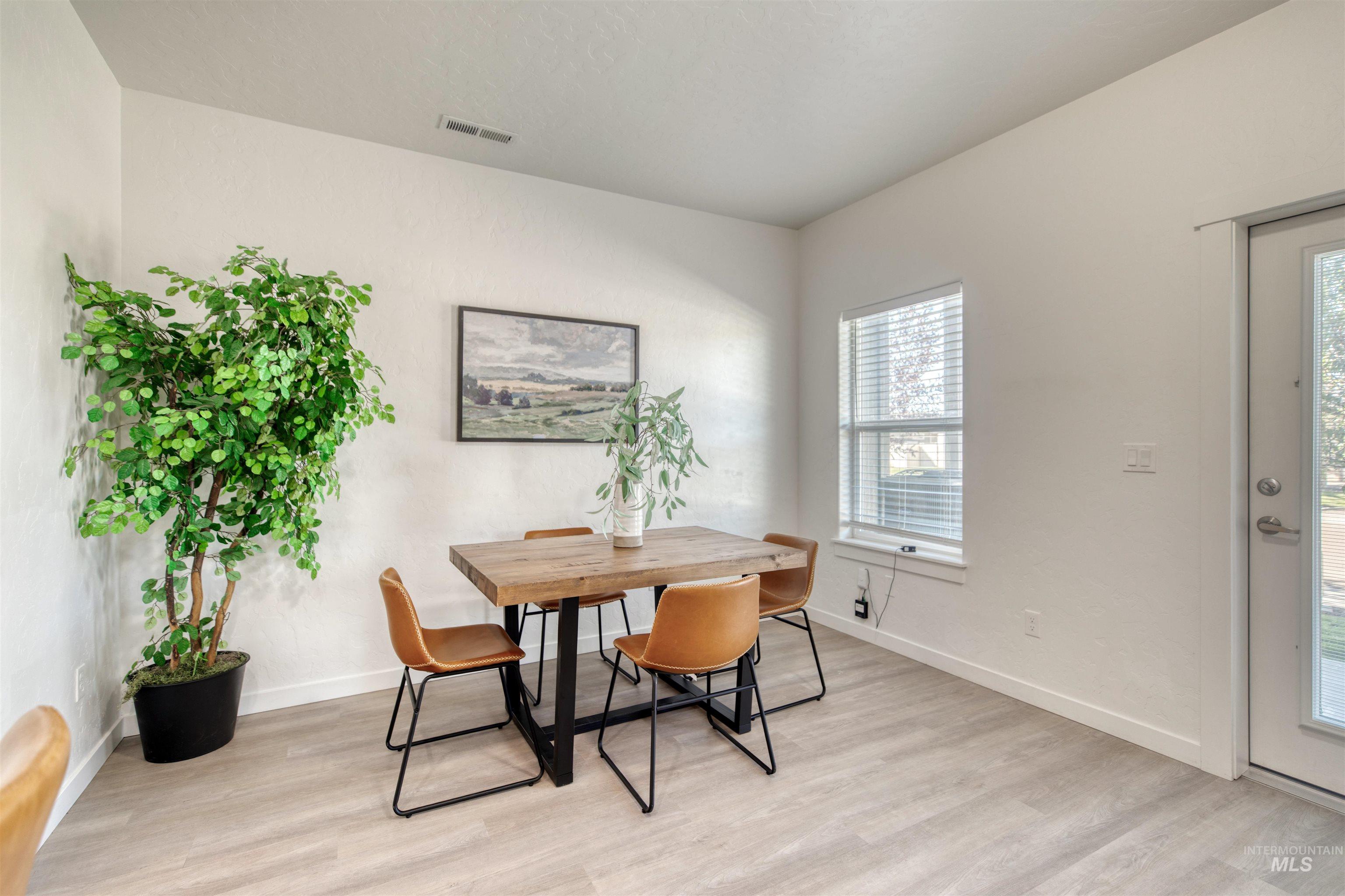 Dining area featuring light wood finished floors and baseboards