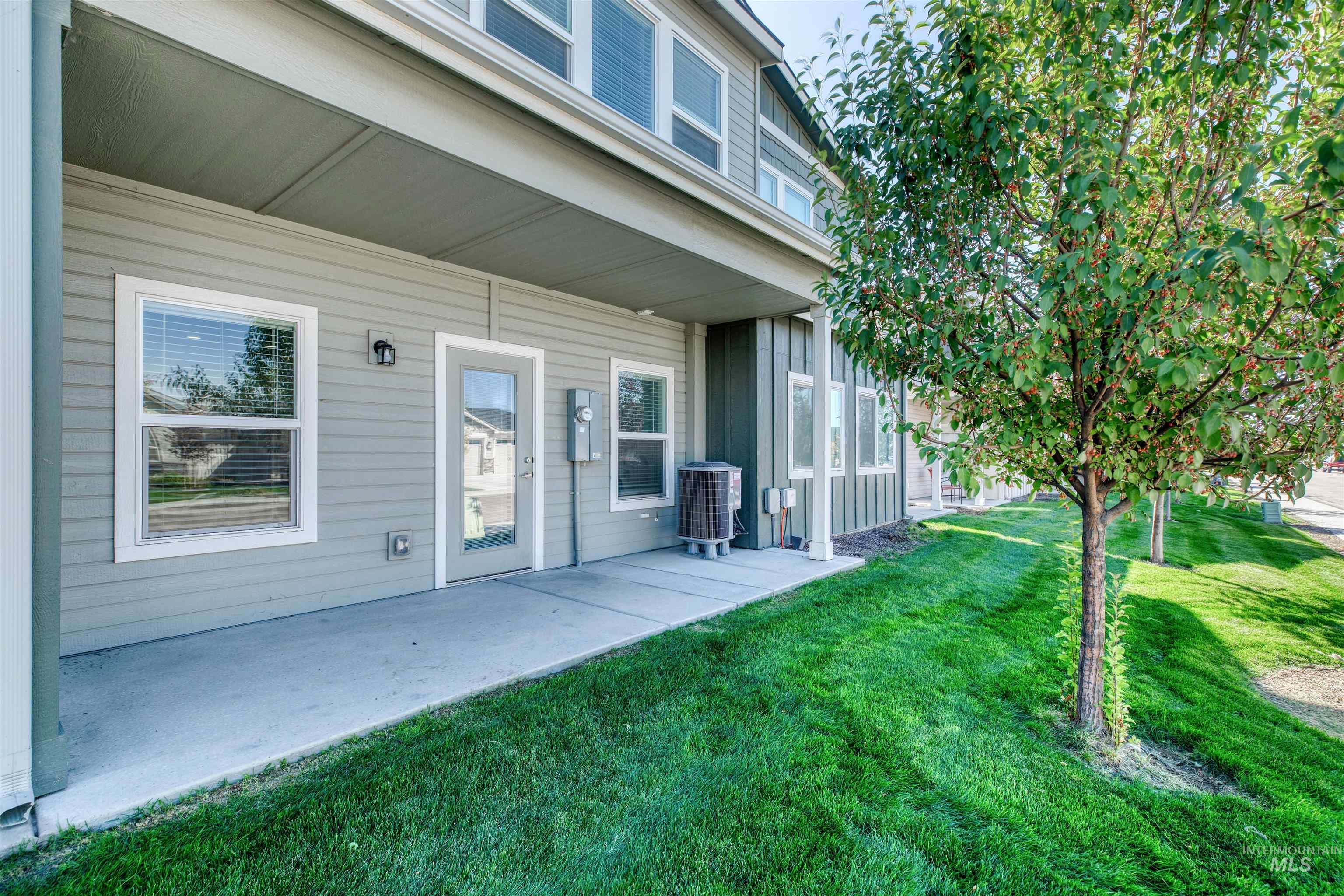 Doorway to property featuring a patio area and a yard