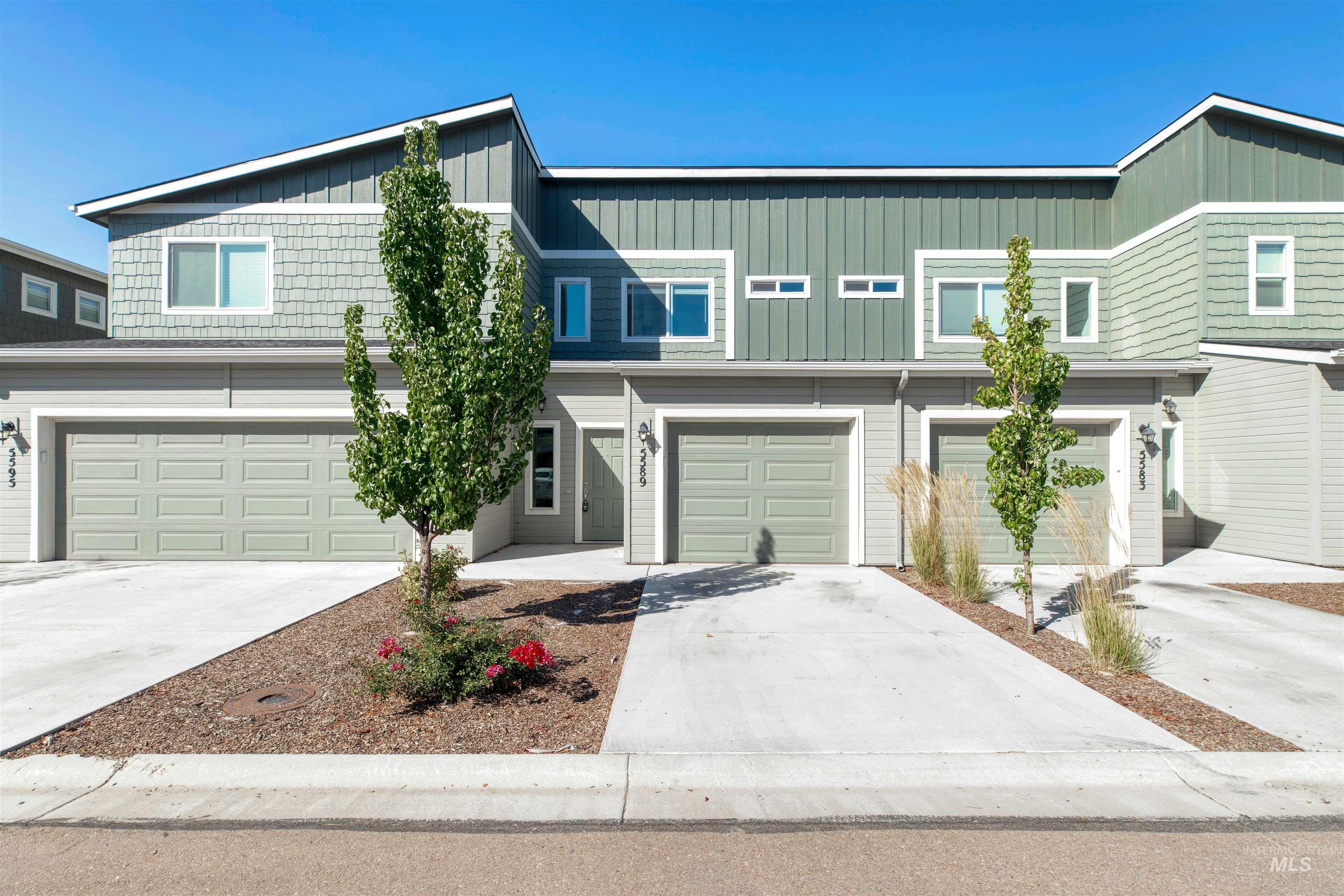 Traditional-style house with driveway, board and batten siding, and an attached garage