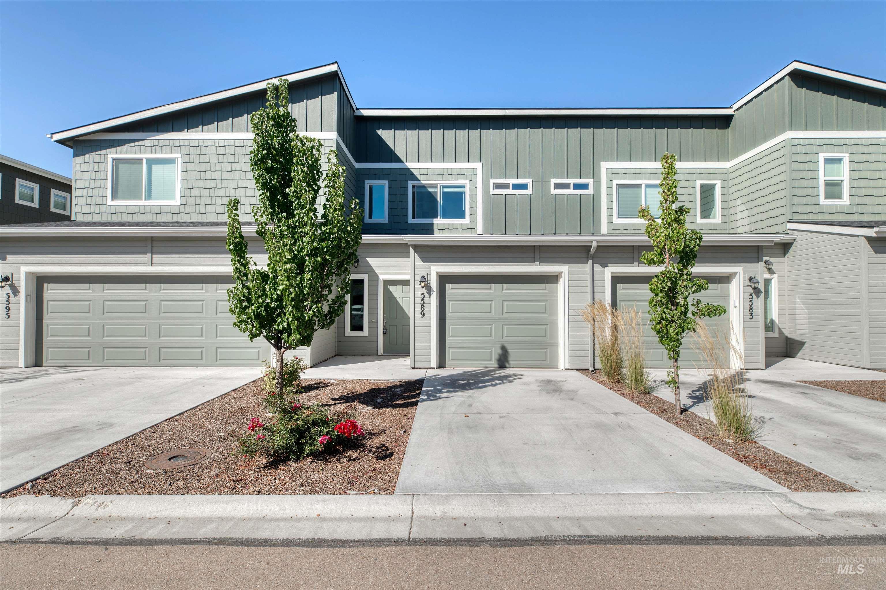 Traditional-style house featuring concrete driveway, board and batten siding, and a garage