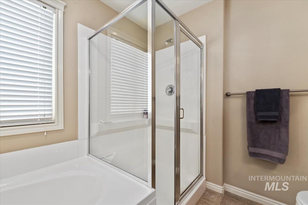 Primary Bedroom's en suite Bathroom, featuring a shower and soaking tub
