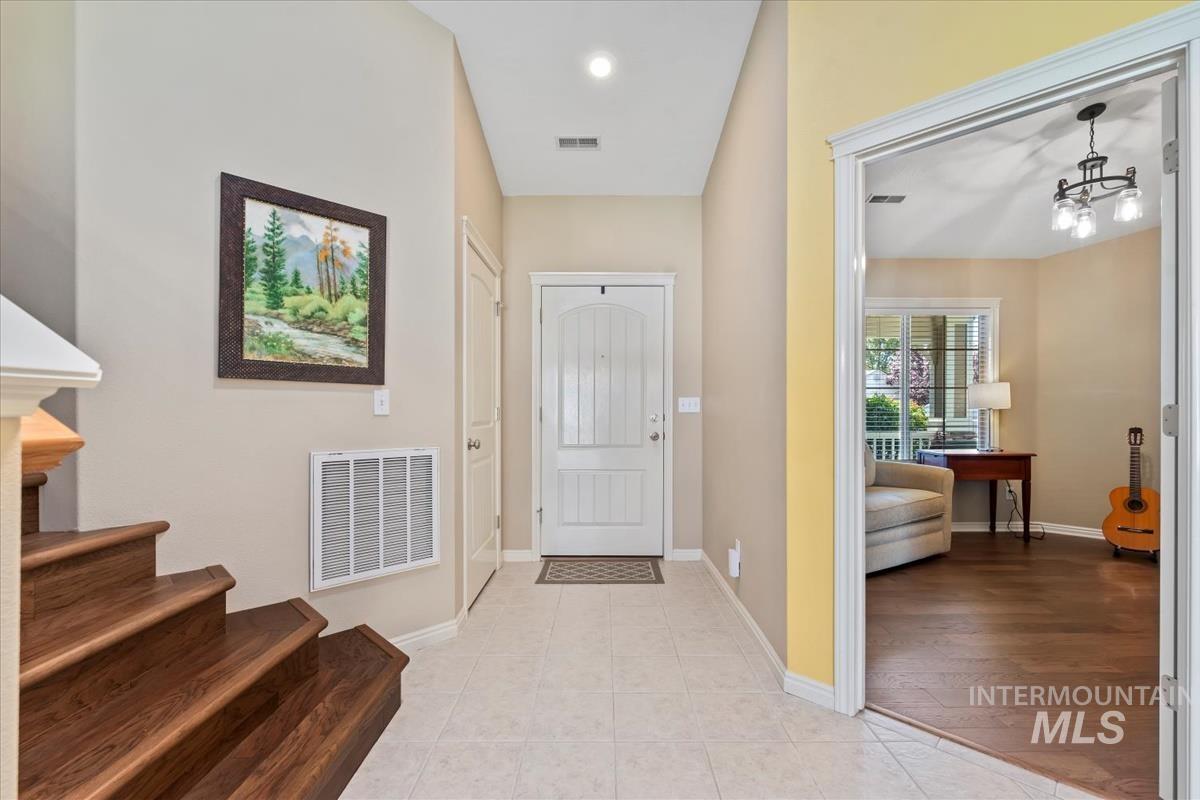 Entry with stairs up to second floor on the left and Den/Office on the right