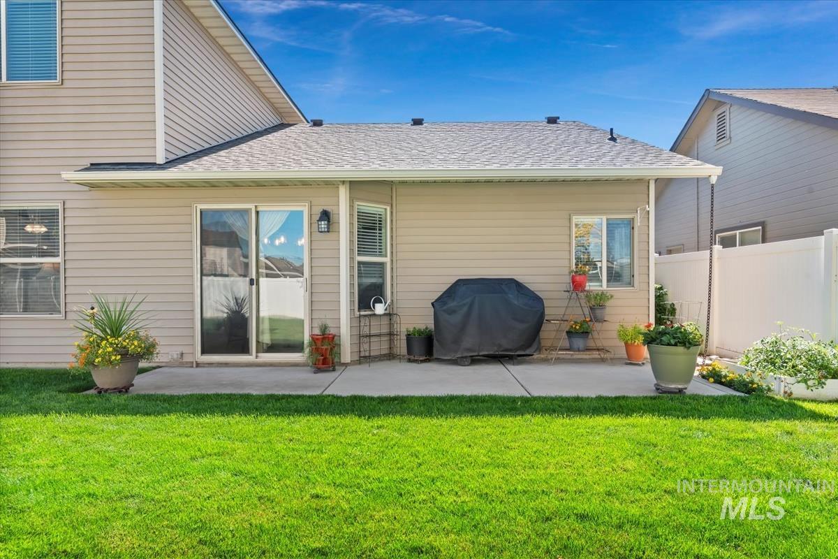 Rear view of house with a patio and a Brand new shingled roof