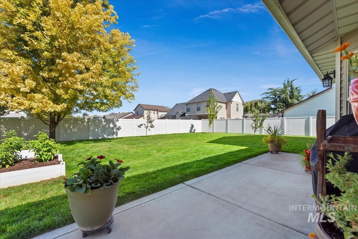 Spacious fenced backyard with a patio