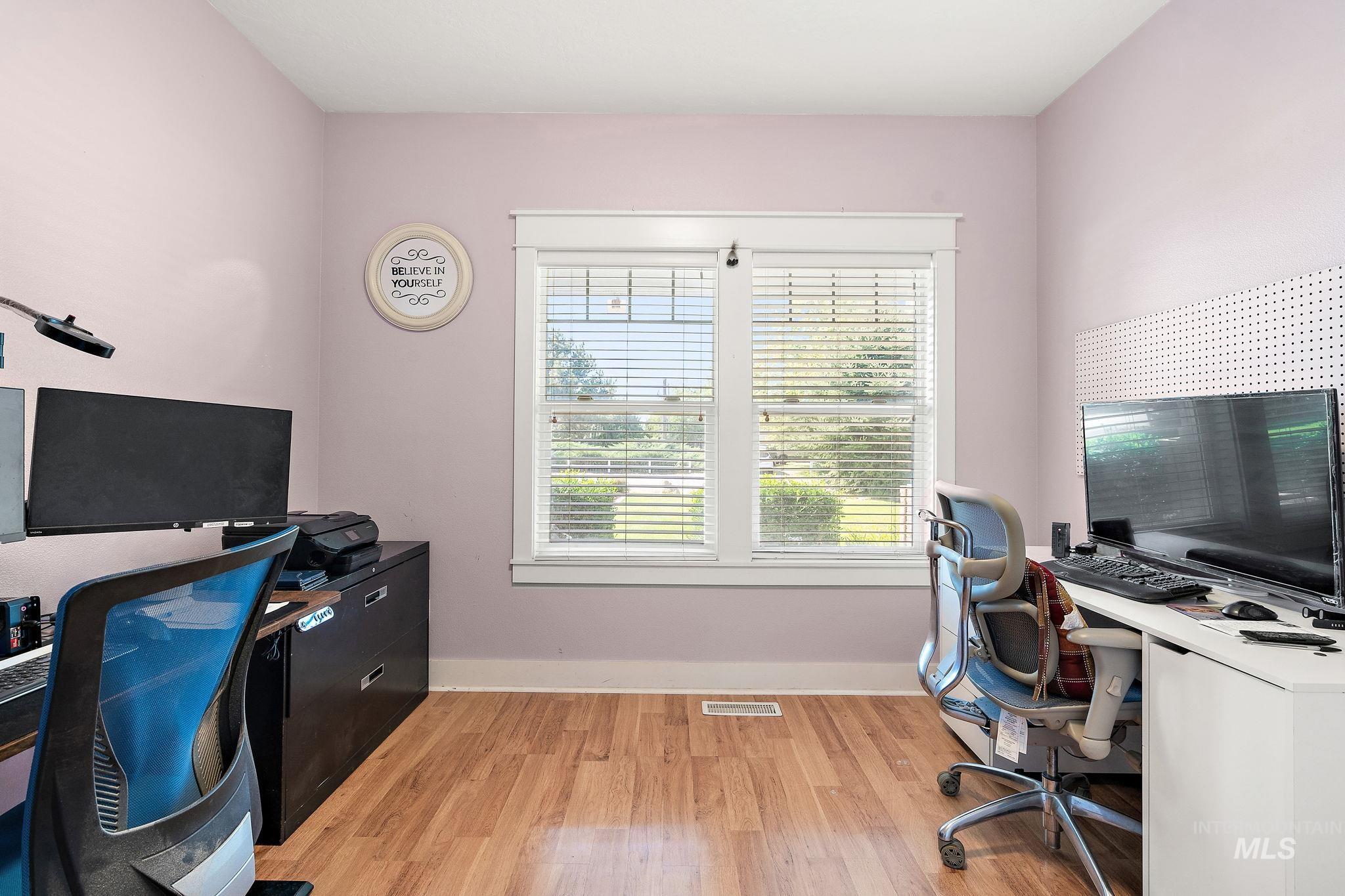 Office with light wood finished floors and baseboards