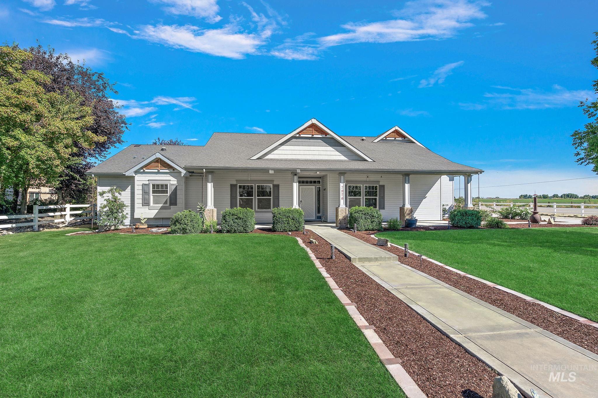 View of front of home with a porch and roof with shingles