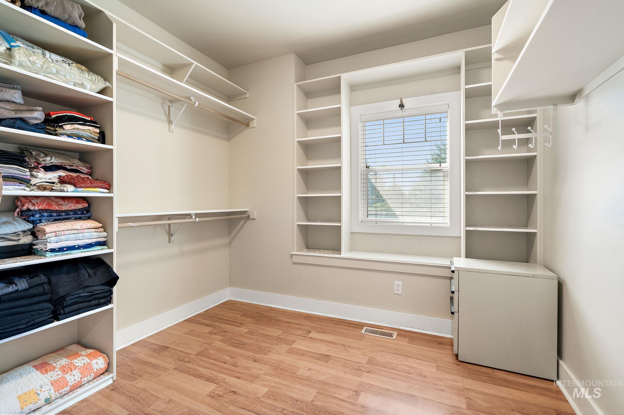 Walk in closet featuring light wood-style flooring