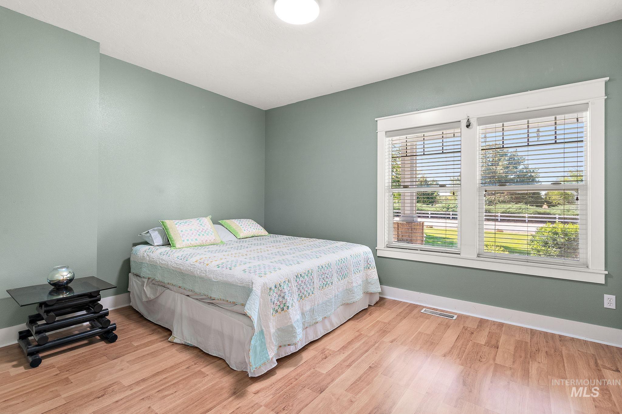 Bedroom featuring light wood finished floors and baseboards