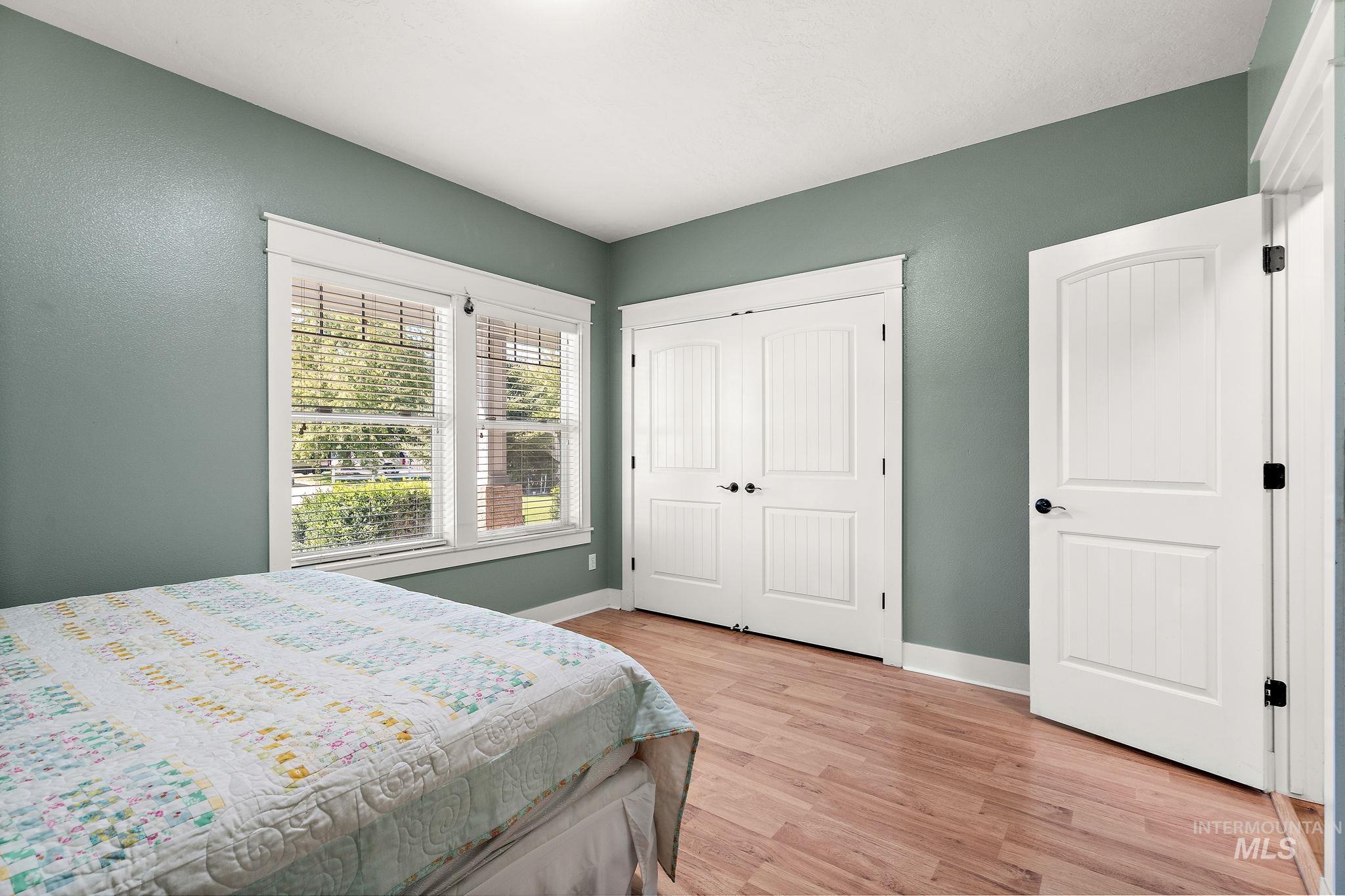 Bedroom featuring light wood-style floors and a closet