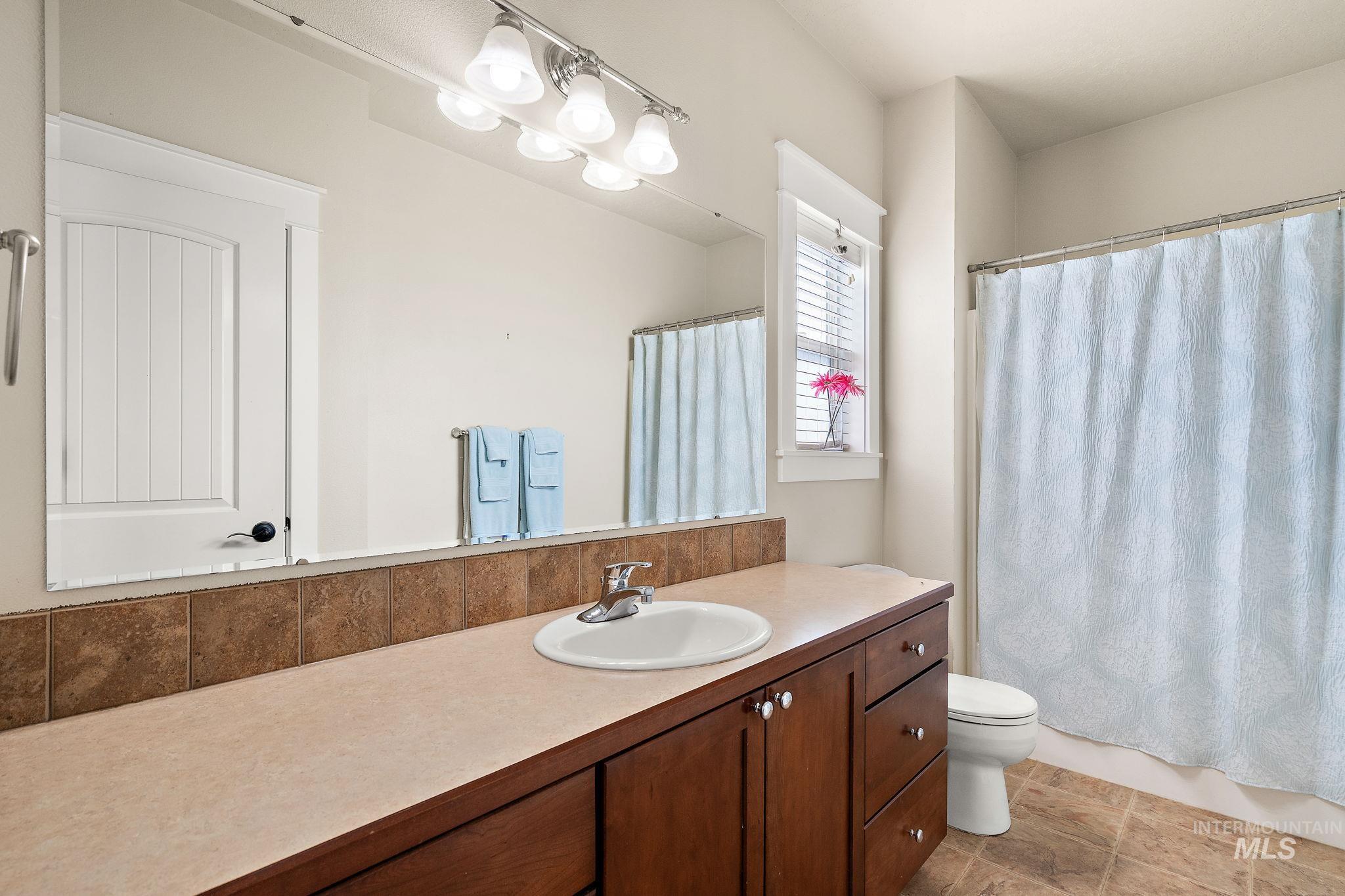 Bathroom with vanity and a shower with curtain