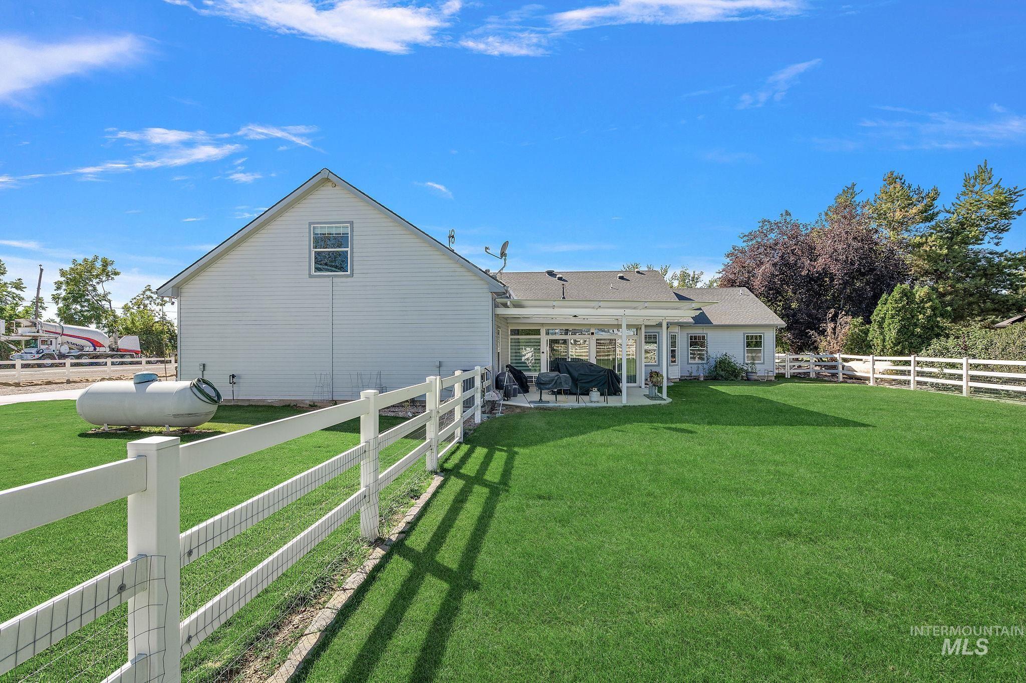 Back of property with a patio and a fenced backyard