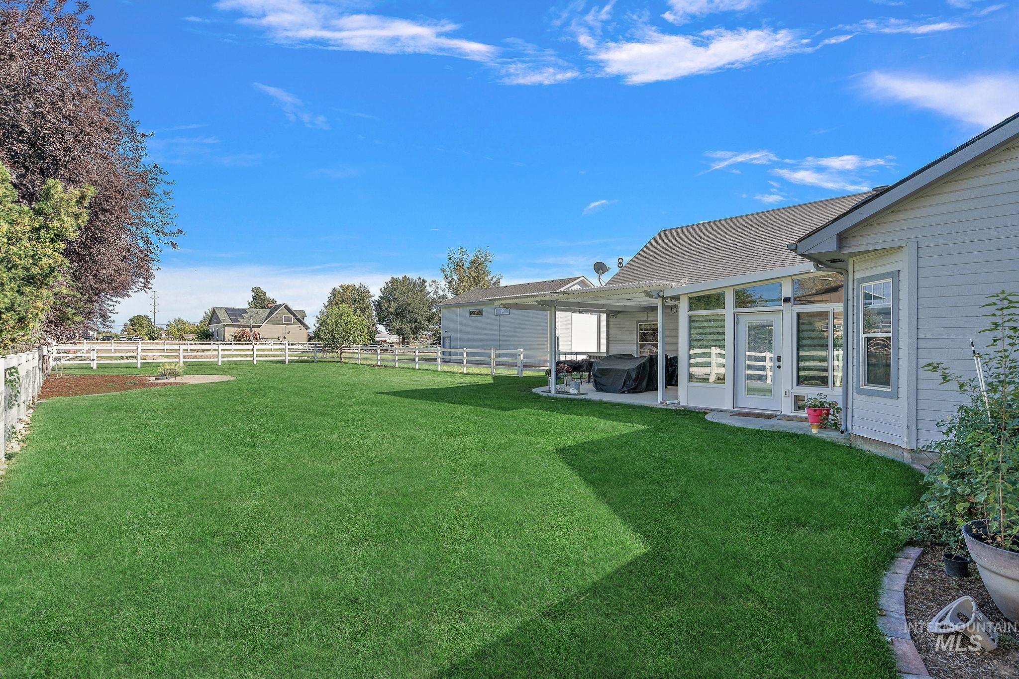 Fenced backyard featuring a patio