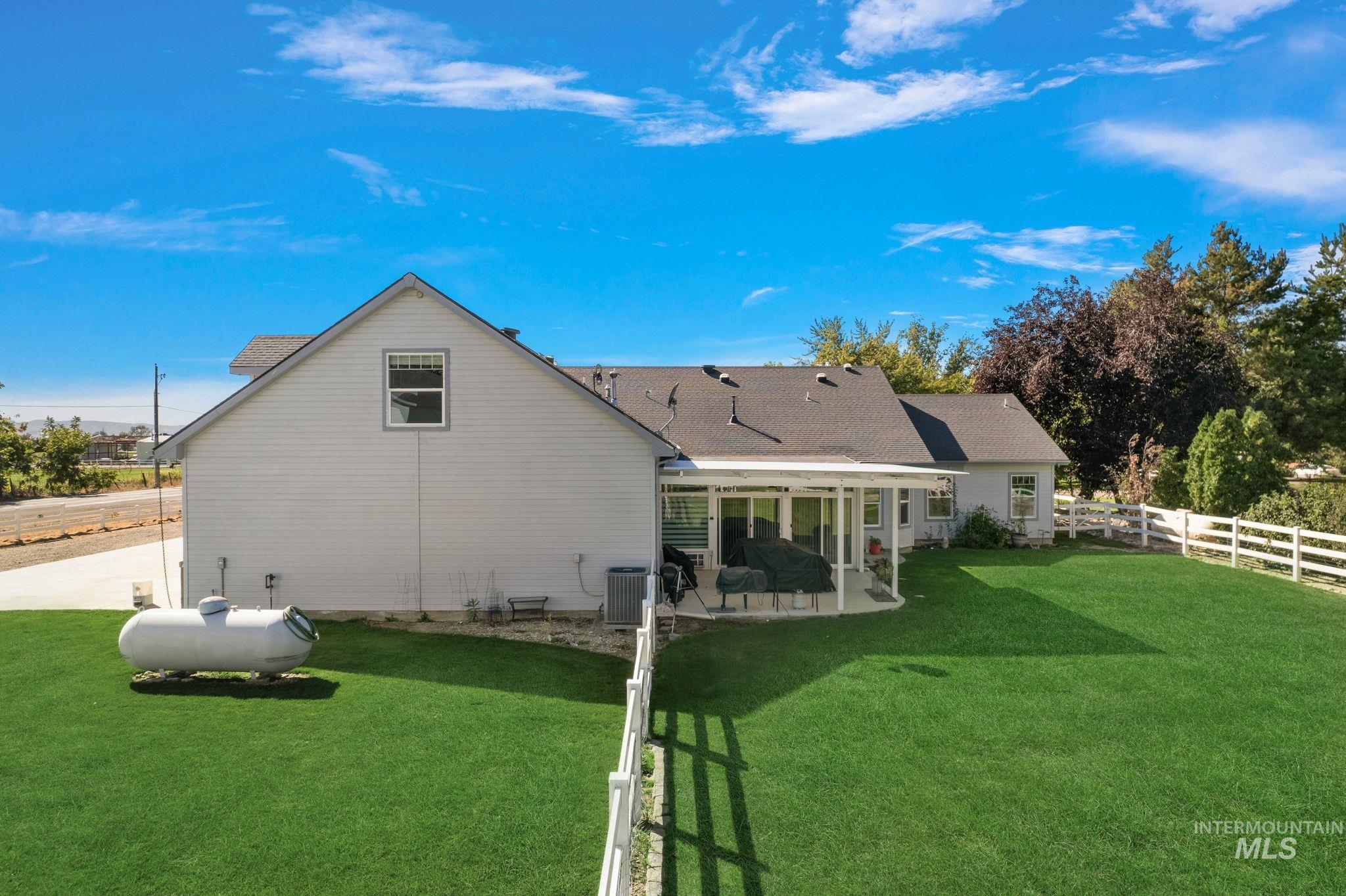 Rear view of property with a patio and a fenced backyard