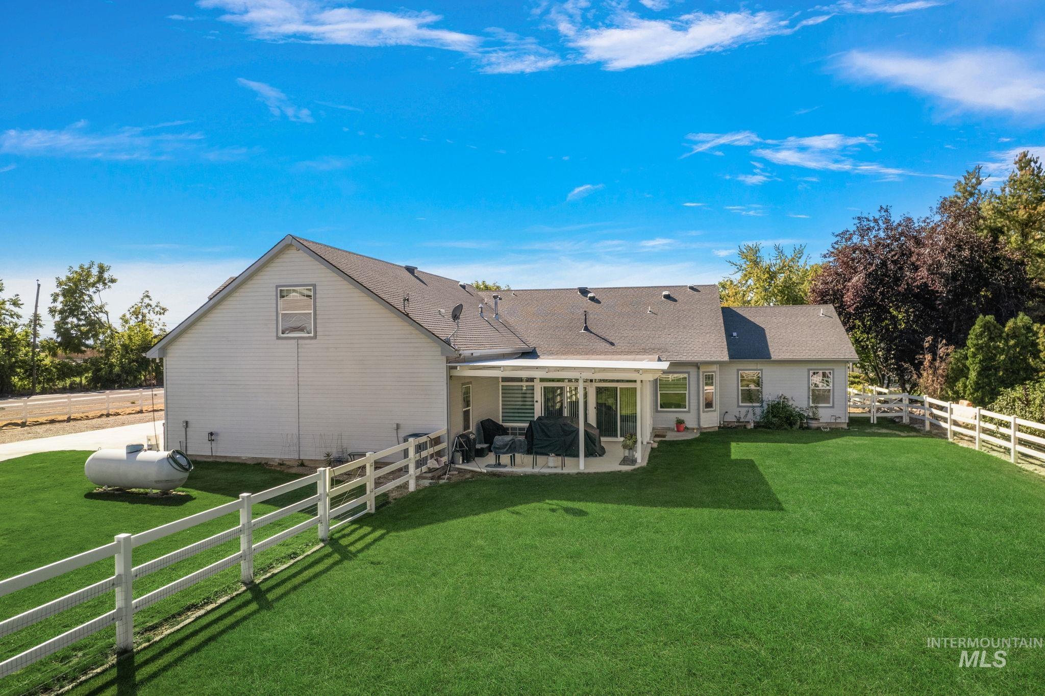 Back of house featuring a fenced backyard and a patio area