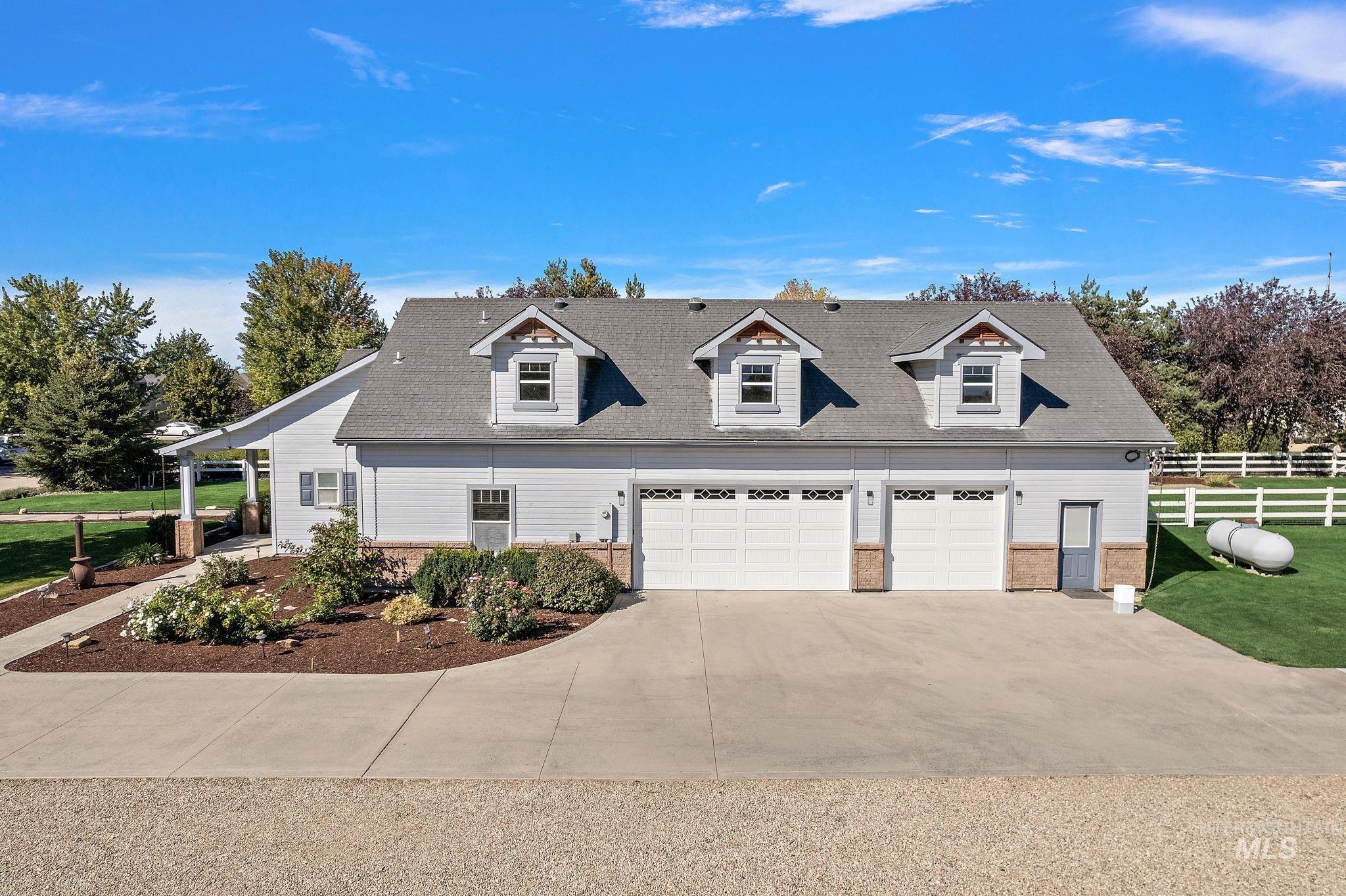 Cape cod house with concrete driveway and brick siding