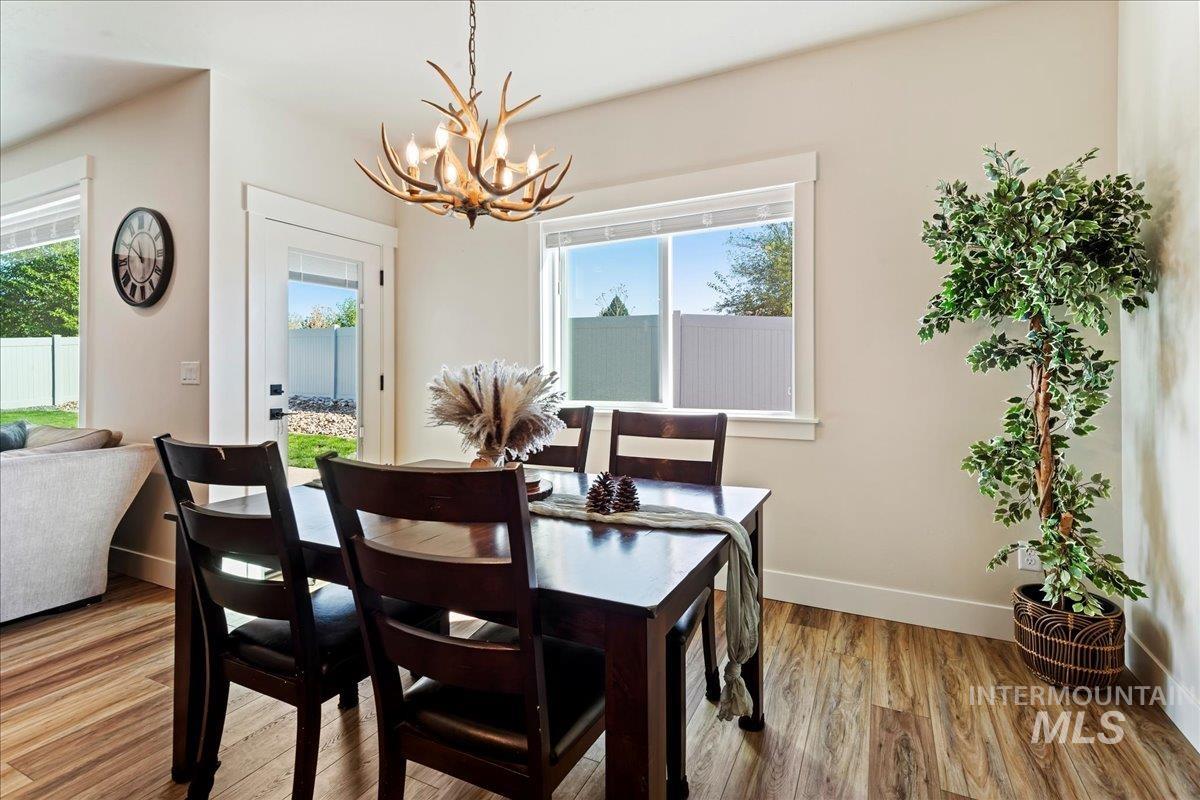 Dining area featuring light wood-style floors and a chandelier