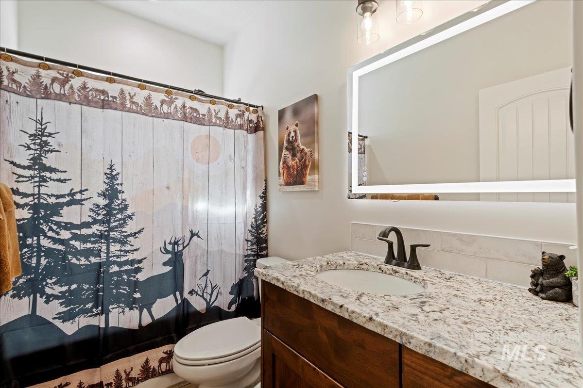 Bathroom featuring vanity and curtained shower