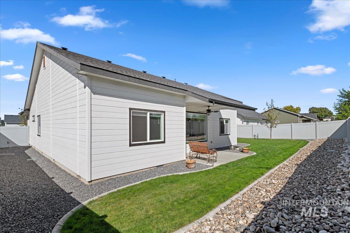 Back of house featuring a patio, a ceiling fan, and a fenced backyard