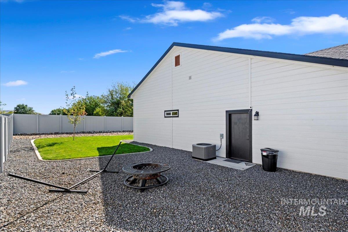 View of home's exterior with a fire pit and a fenced backyard