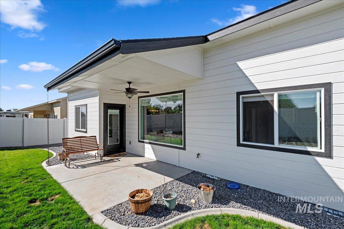 View of exterior entry featuring a patio and ceiling fan