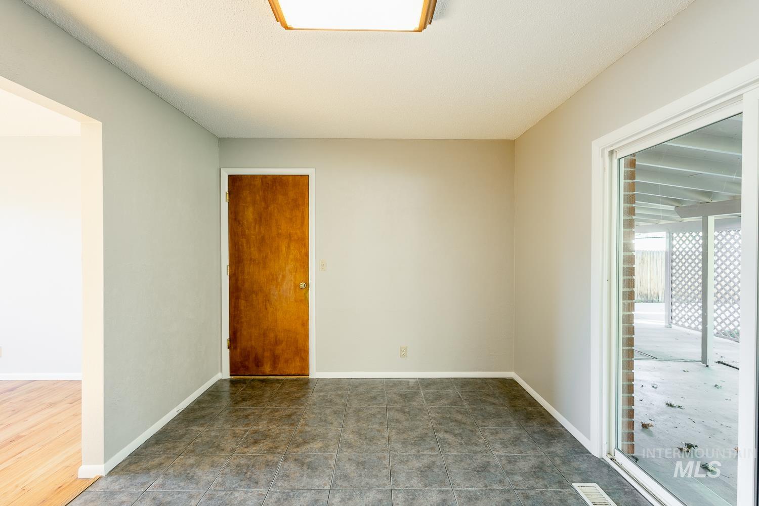 Spare room featuring baseboards