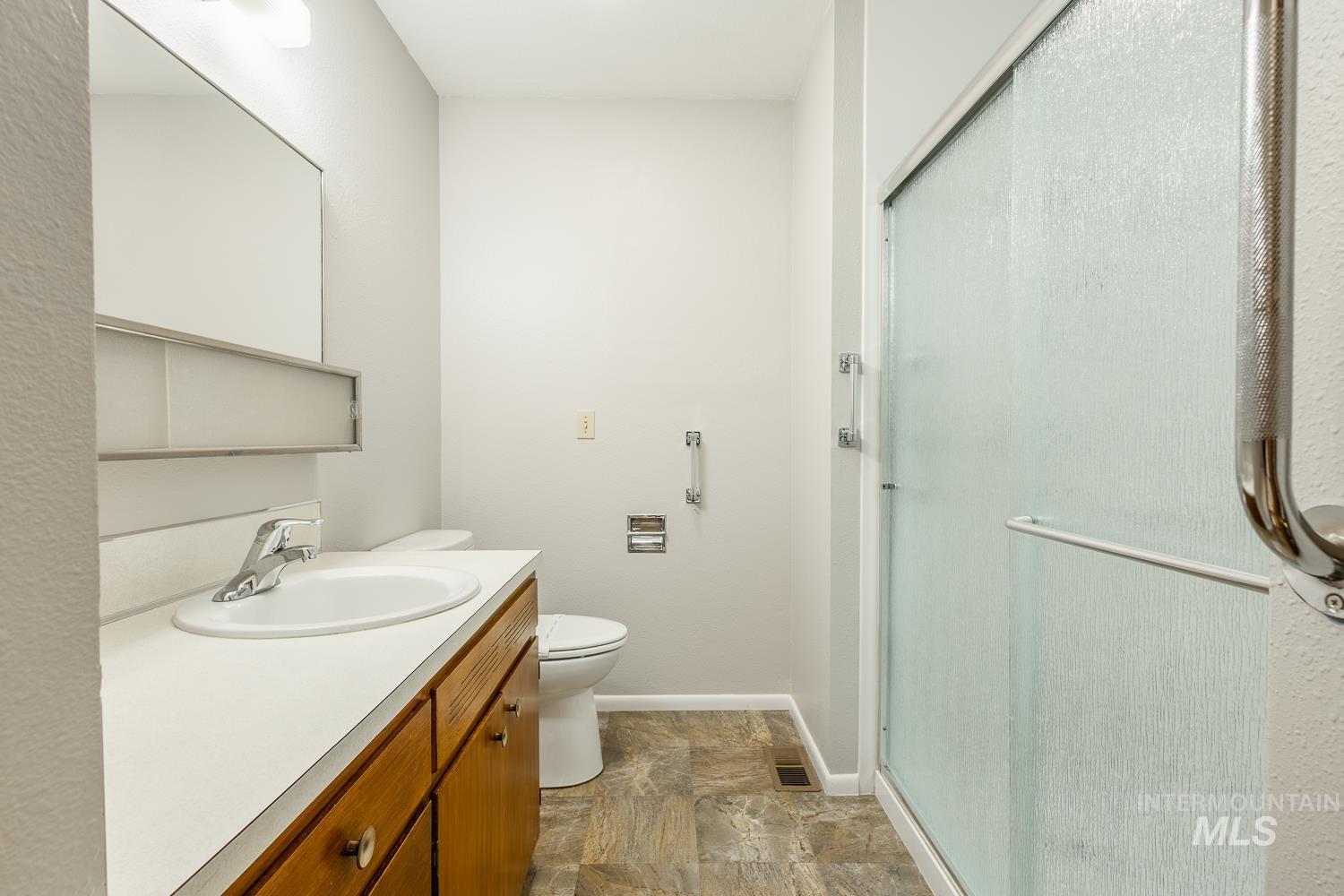 Full bathroom featuring vanity and a stall shower